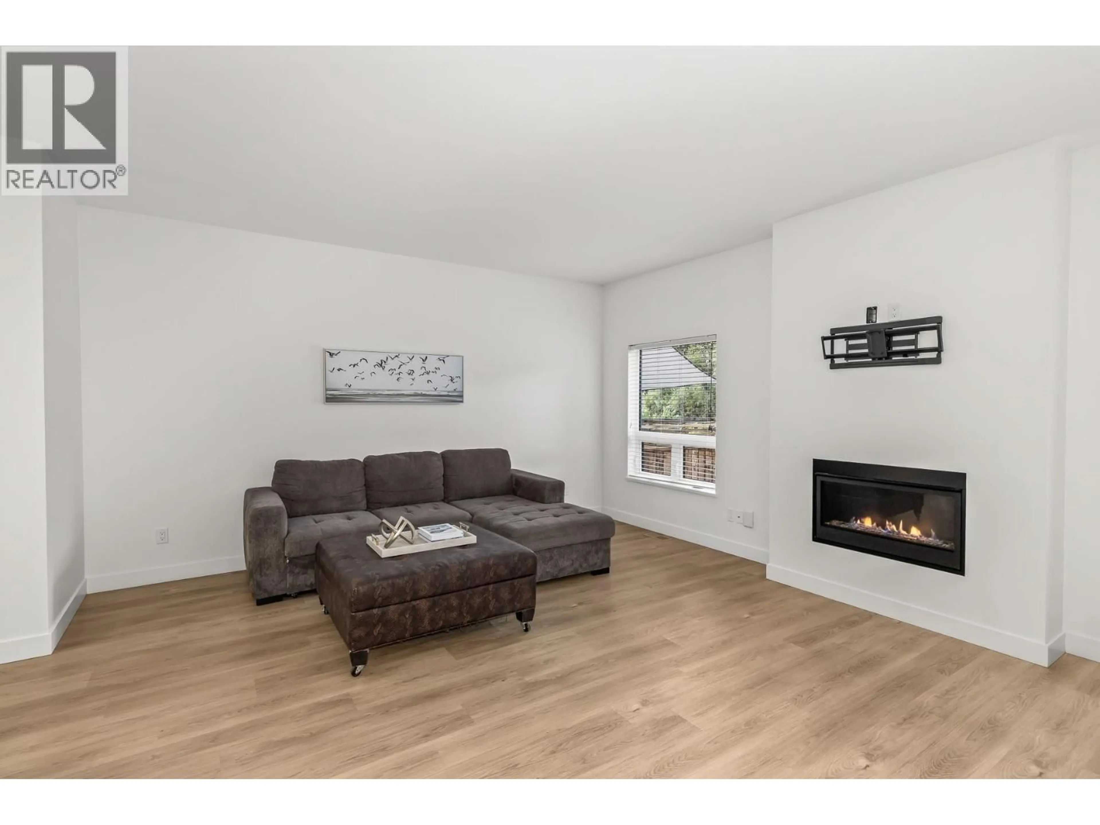 Living room with furniture, wood/laminate floor for 103 - 5011 TOWGOOD PLACE, Summerland British Columbia V0H1Z9