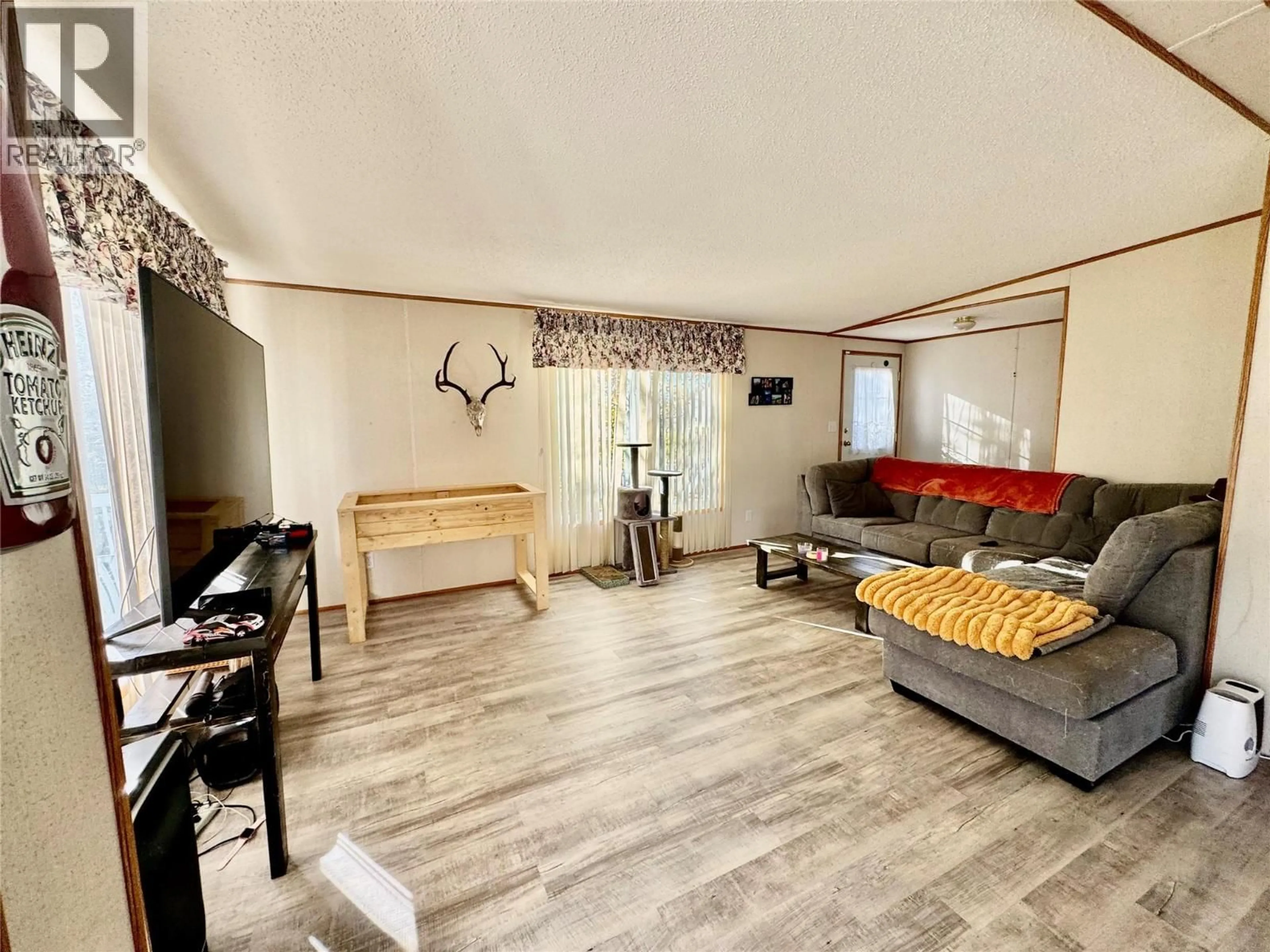 Living room with furniture, wood/laminate floor for 4806 55 AVENUE, Pouce Coupe British Columbia V0C2C0