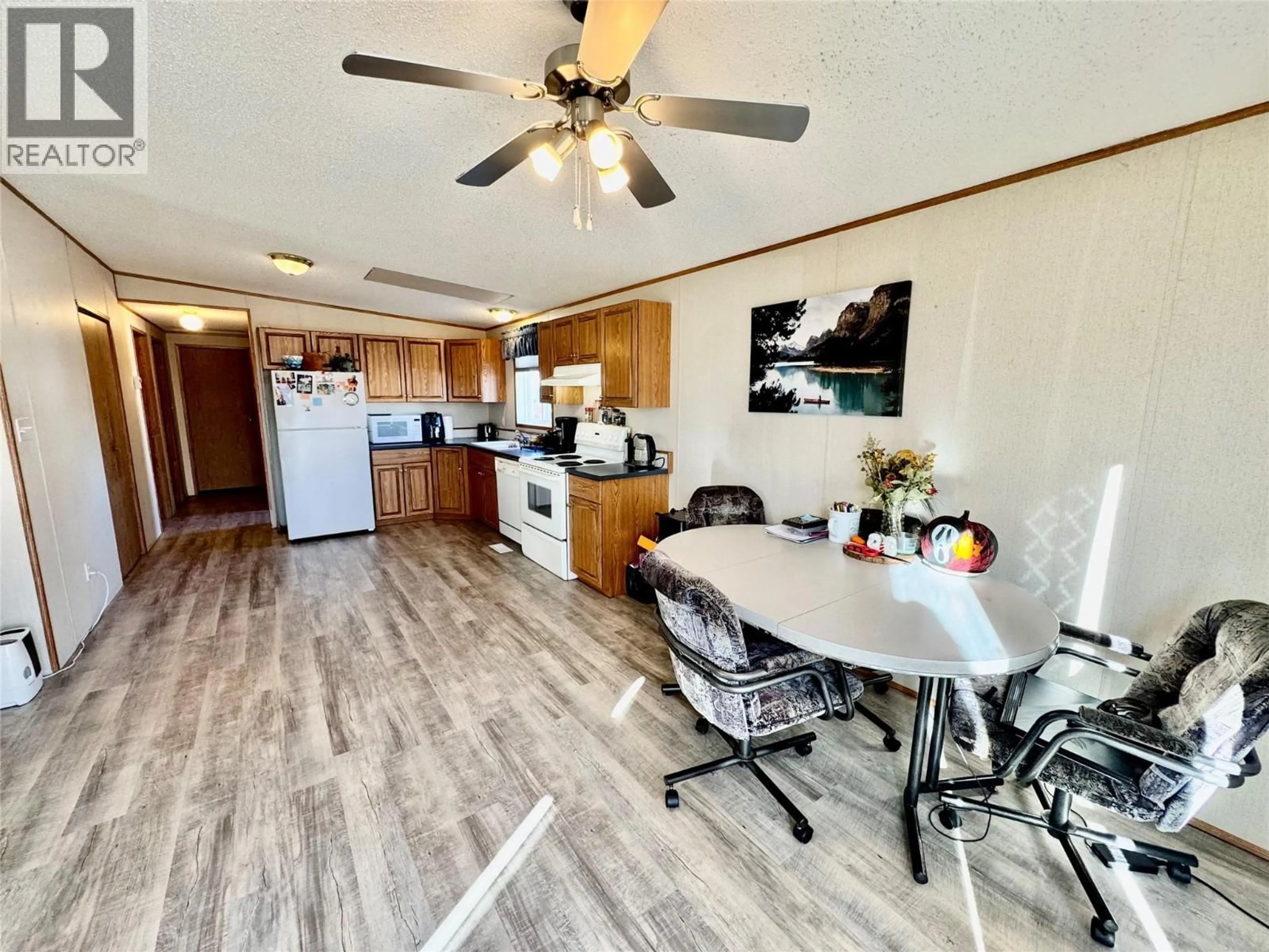 Open concept kitchen, wood/laminate floor for 4806 55 AVENUE, Pouce Coupe British Columbia V0C2C0