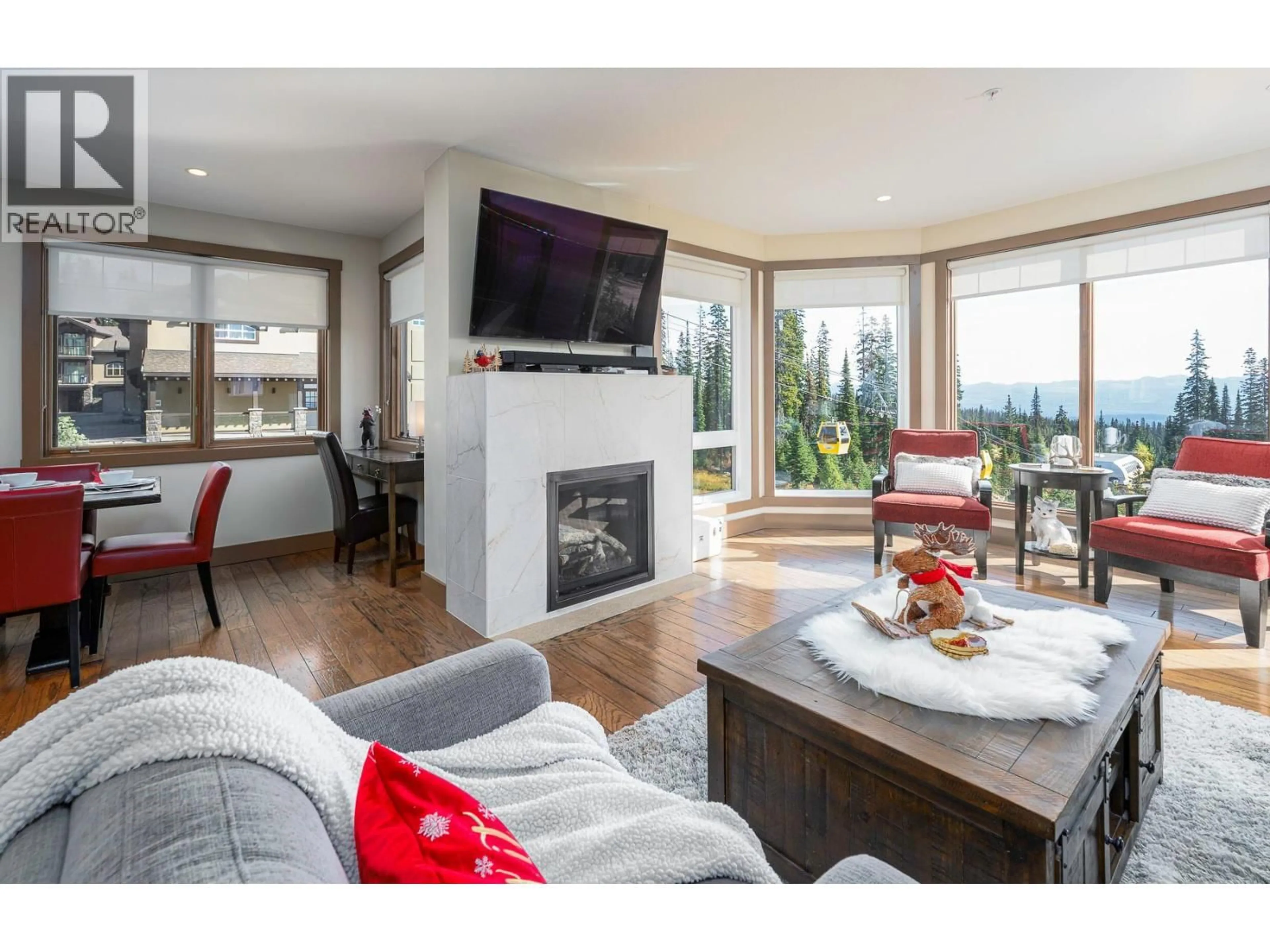 Living room with furniture, wood/laminate floor for 103 - 5085 SNOWBIRD WAY, Big White British Columbia V1P1P3
