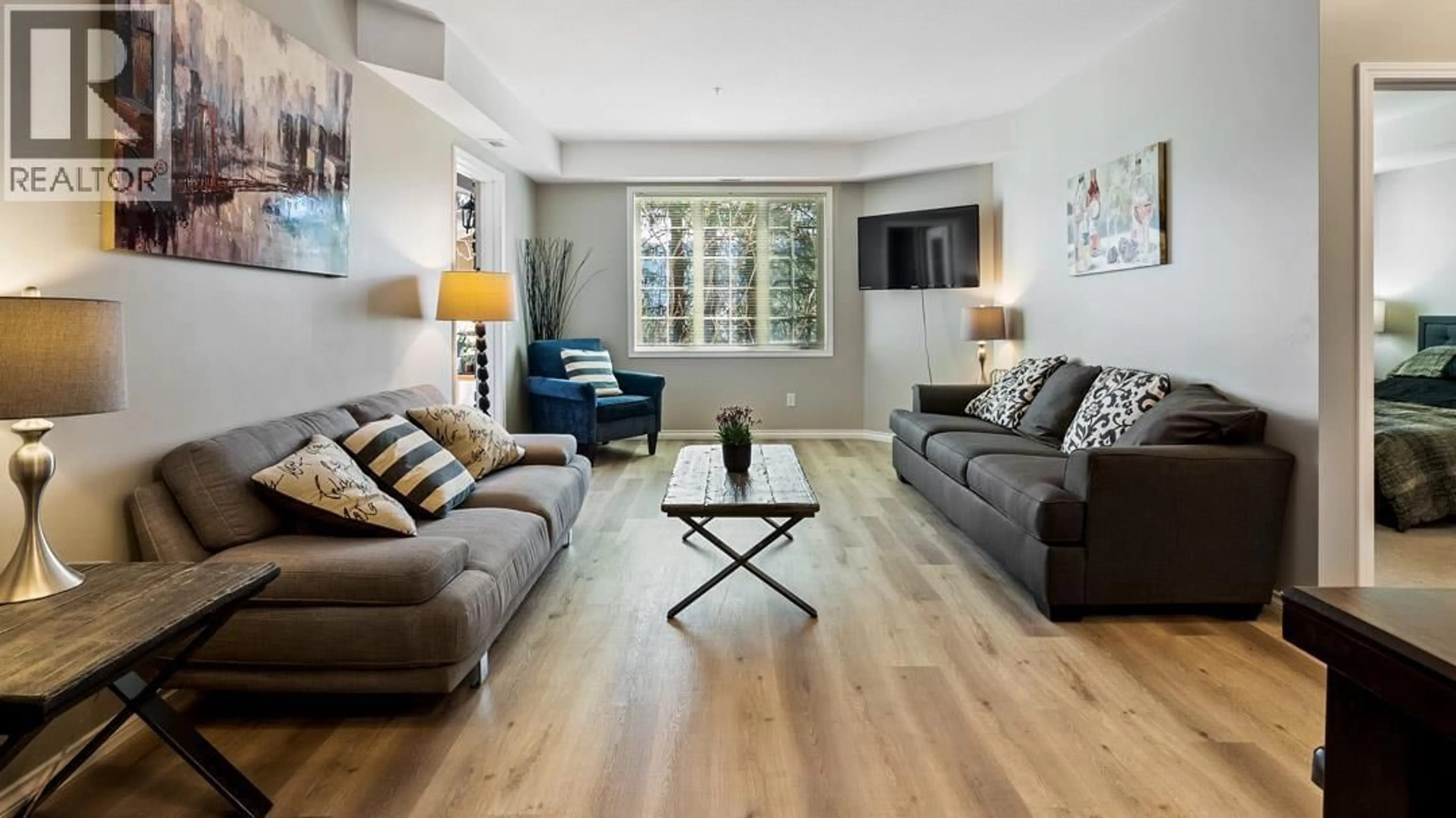 Living room with furniture, wood/laminate floor for 2112 - 1873 COUNTRY CLUB DRIVE, Kelowna British Columbia V1V2W6