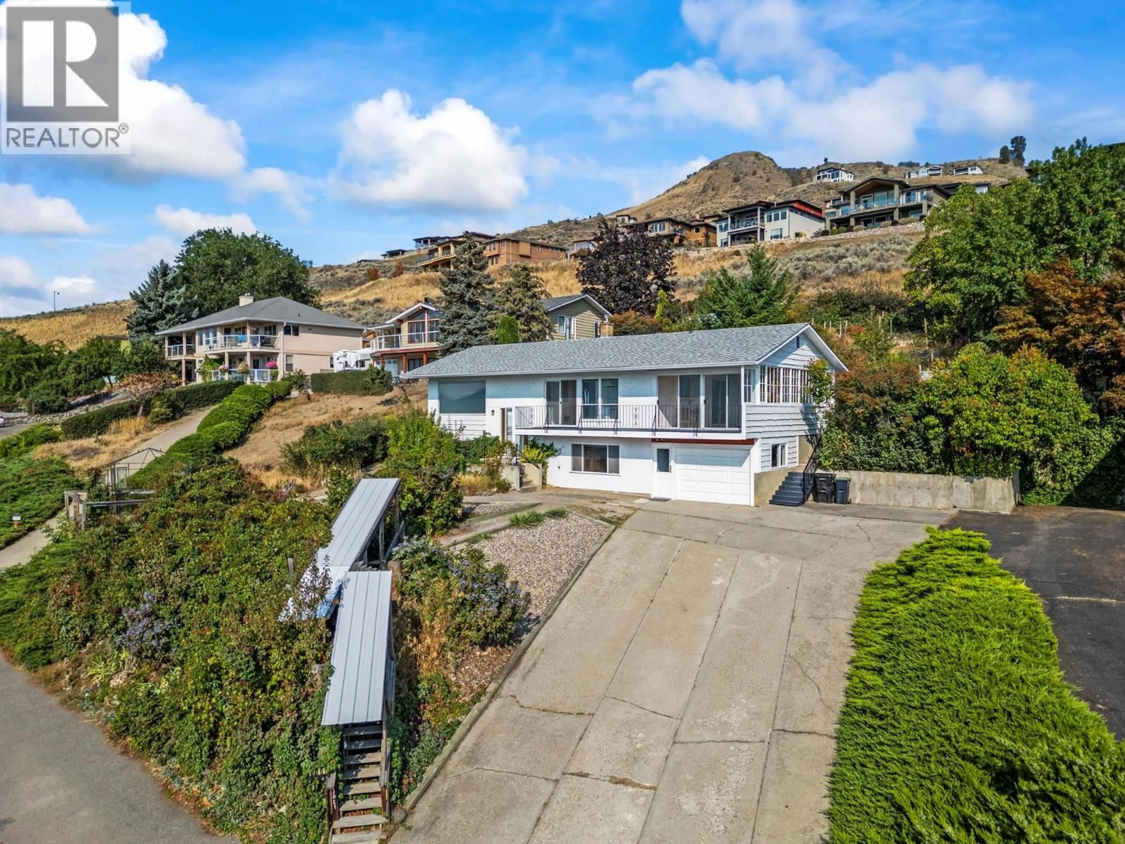 A pic from outside/outdoor area/front of a property/back of a property/a pic from drone, street for 7061 APPALOOSA WAY, Vernon British Columbia V1H1B9