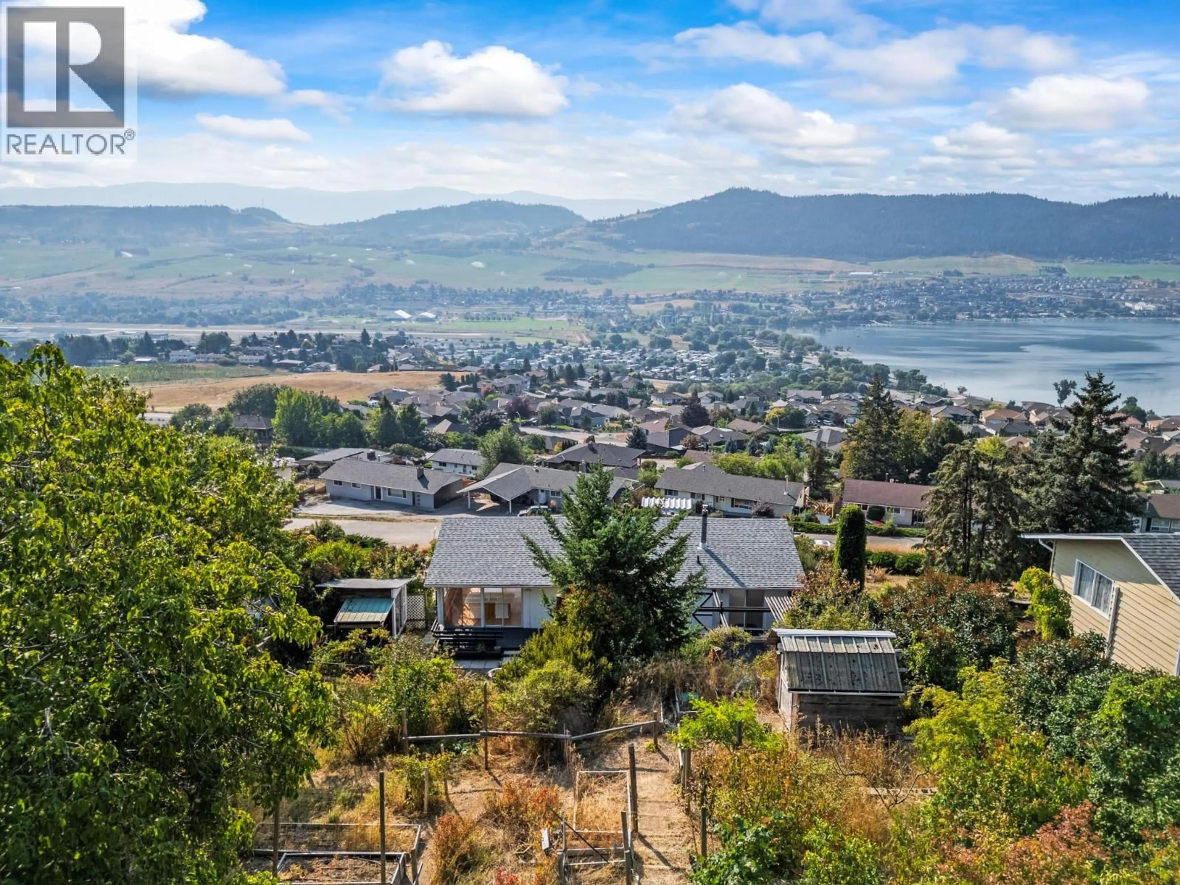 A pic from outside/outdoor area/front of a property/back of a property/a pic from drone, mountain view for 7061 APPALOOSA WAY, Vernon British Columbia V1H1B9