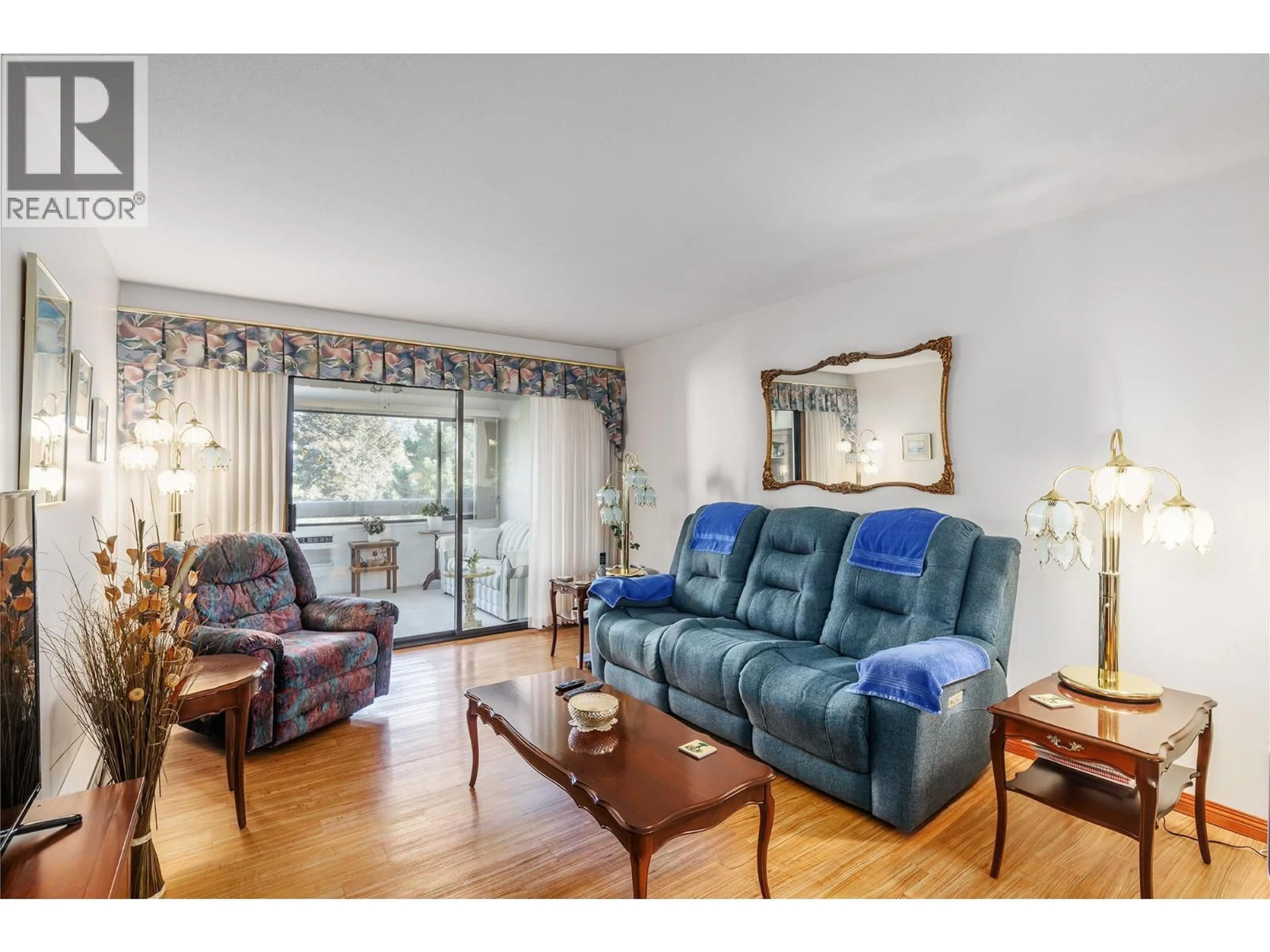 Living room with furniture, wood/laminate floor for 301 - 1075 BERNARD AVENUE, Kelowna British Columbia V1Y6P7