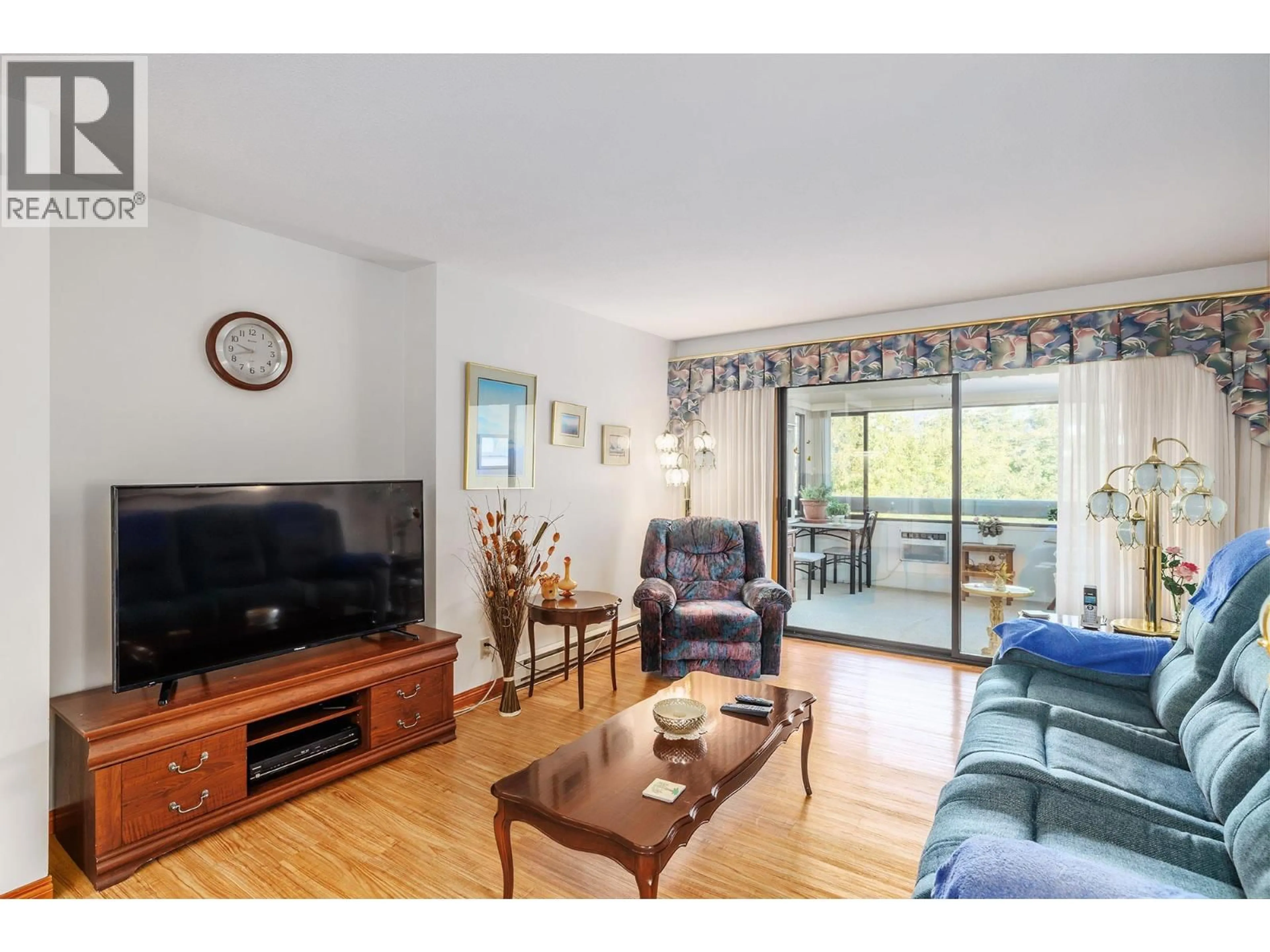 Living room with furniture, wood/laminate floor for 301 - 1075 BERNARD AVENUE, Kelowna British Columbia V1Y6P7