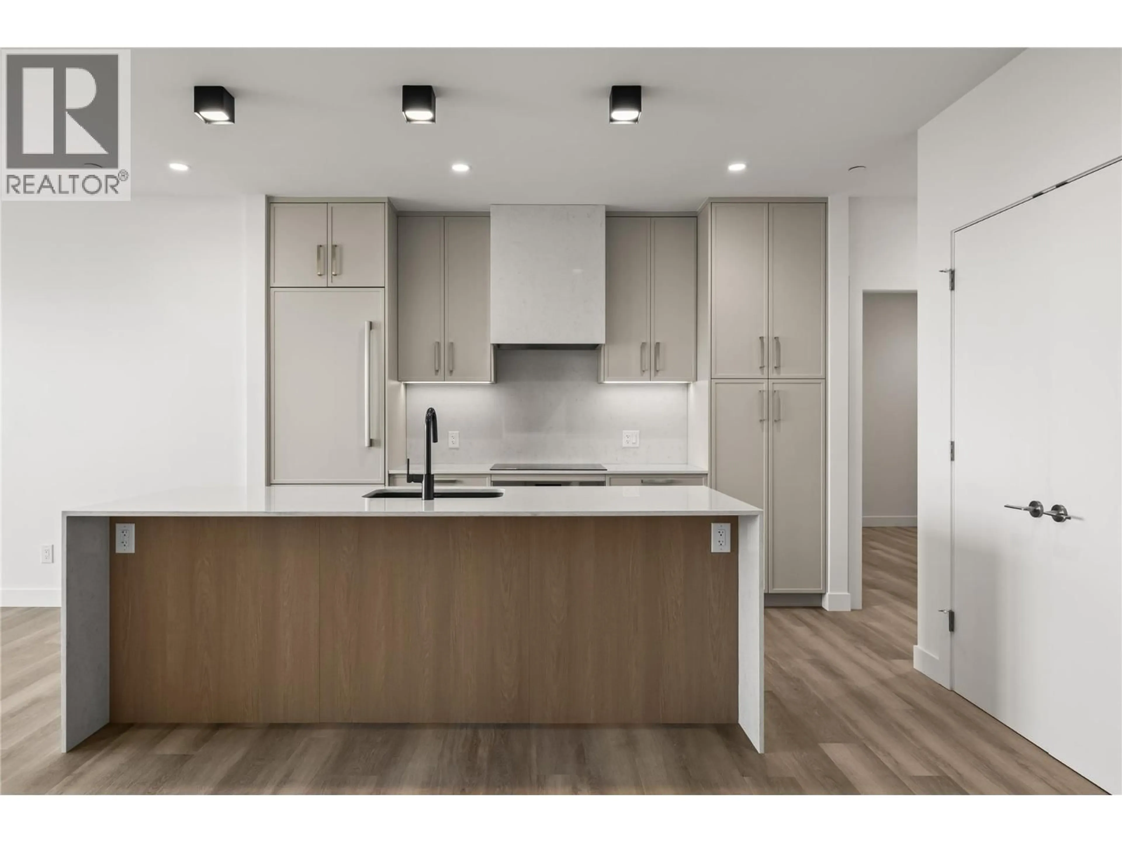 Open concept kitchen, wood/laminate floor for 306 - 3340 LAKESHORE DRIVE, Kelowna British Columbia V1W0H6