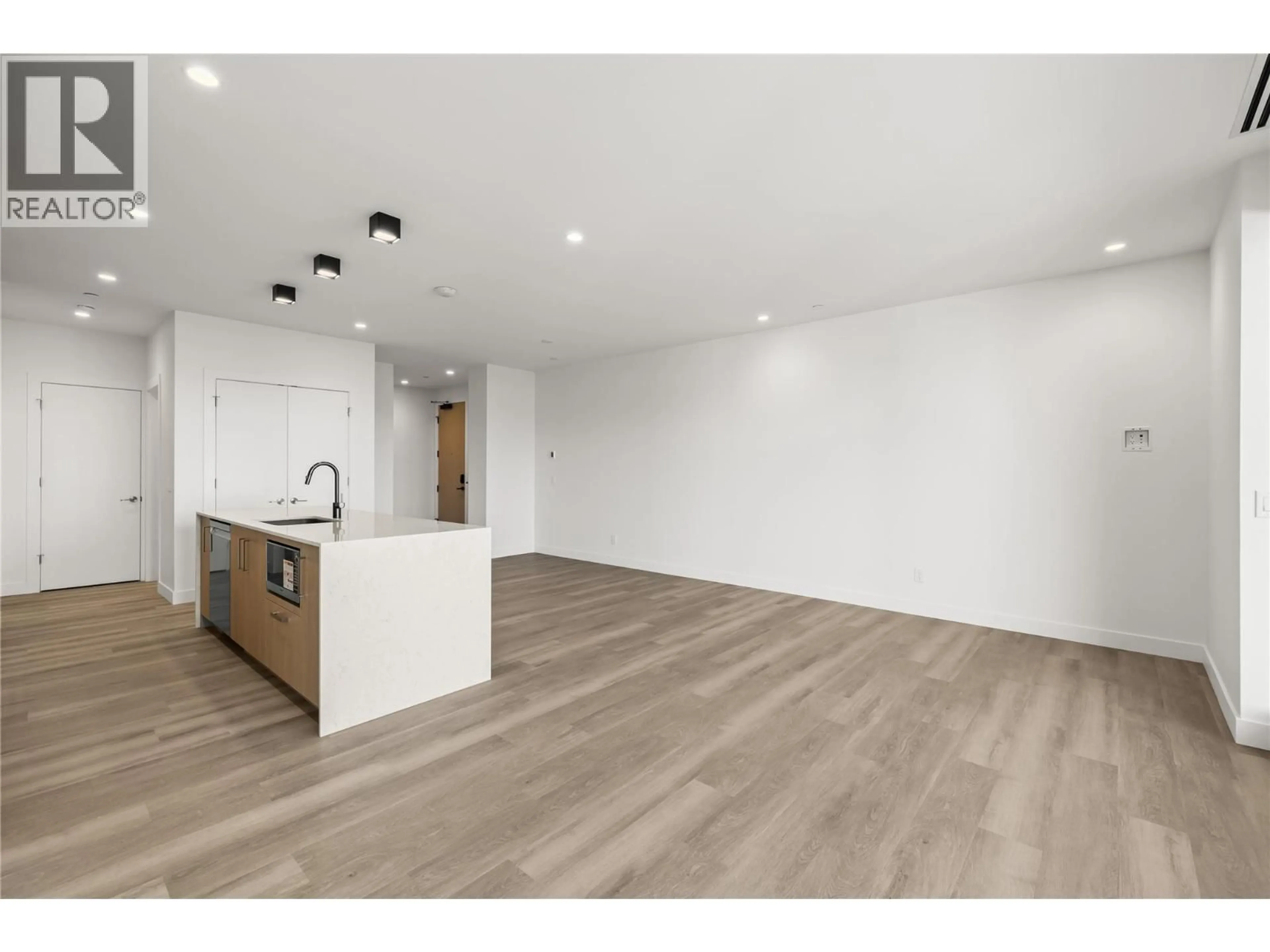 Open concept kitchen, wood/laminate floor for 306 - 3340 LAKESHORE DRIVE, Kelowna British Columbia V1W0H6