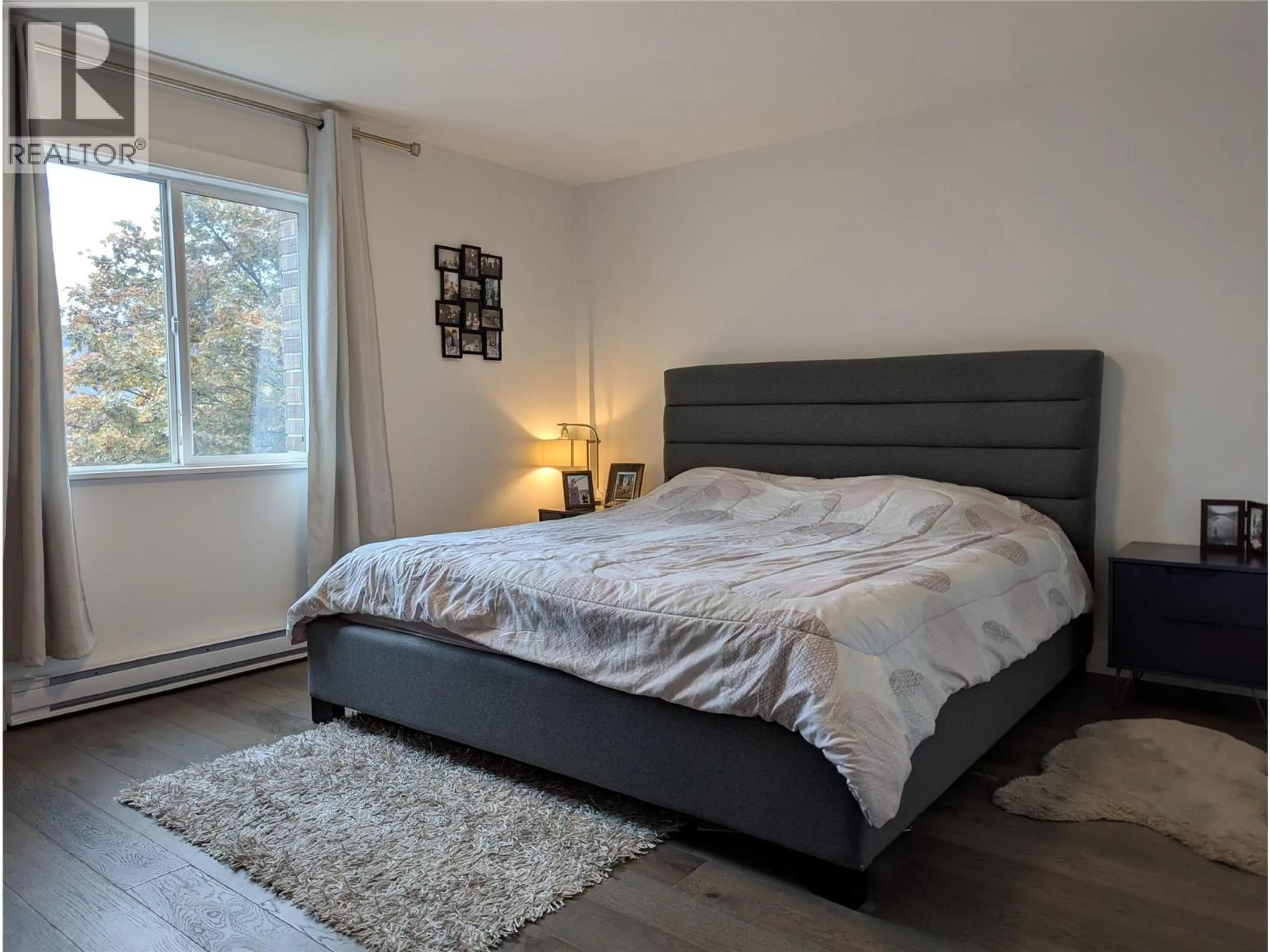 Bedroom with bed, wood/laminate floor for 401 - 1915 PACIFIC COURT, Kelowna British Columbia V1Y8B3