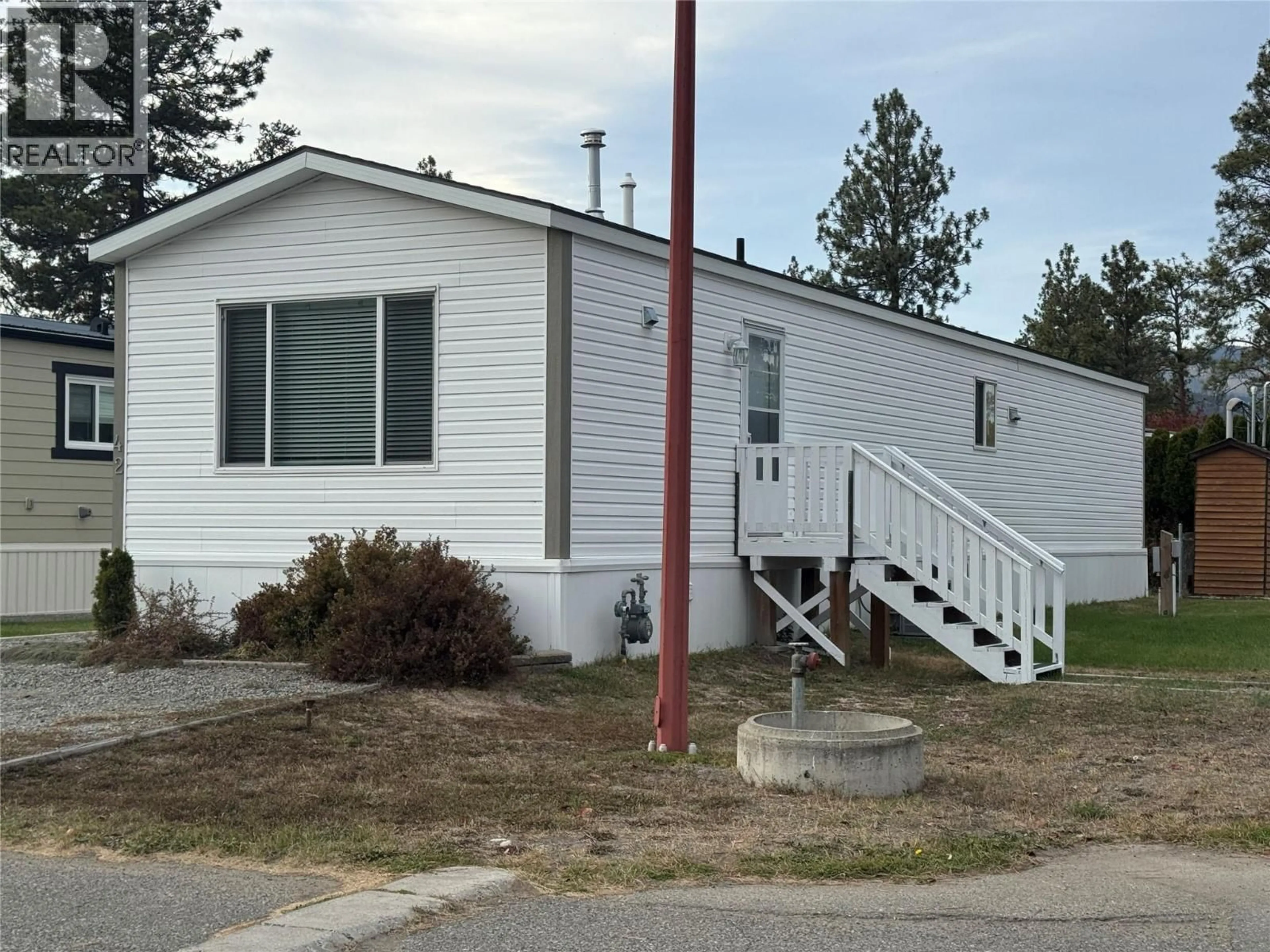 Home with vinyl exterior material, street for 42 - 254 8 HIGHWAY, Merritt British Columbia V1K1M7