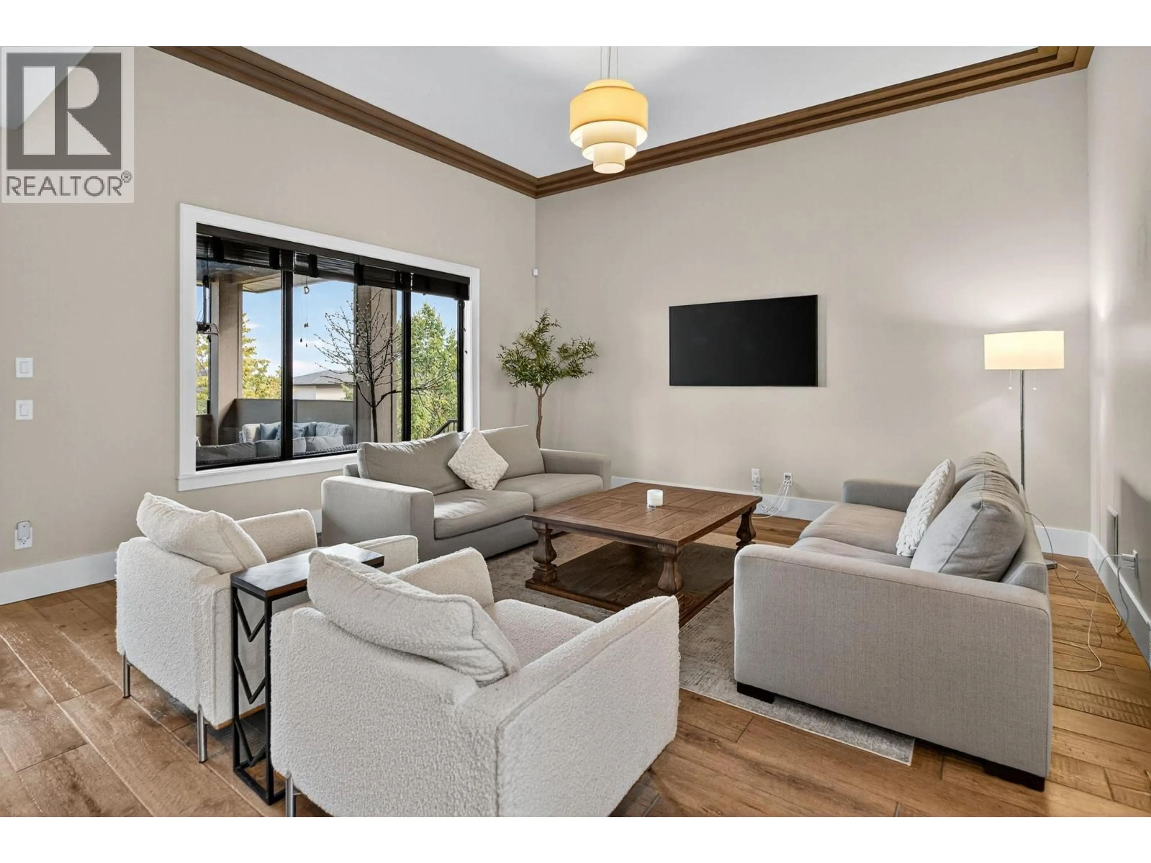 Living room with furniture, wood/laminate floor for 460 ROCKVIEW LANE, Kelowna British Columbia V1W5K2