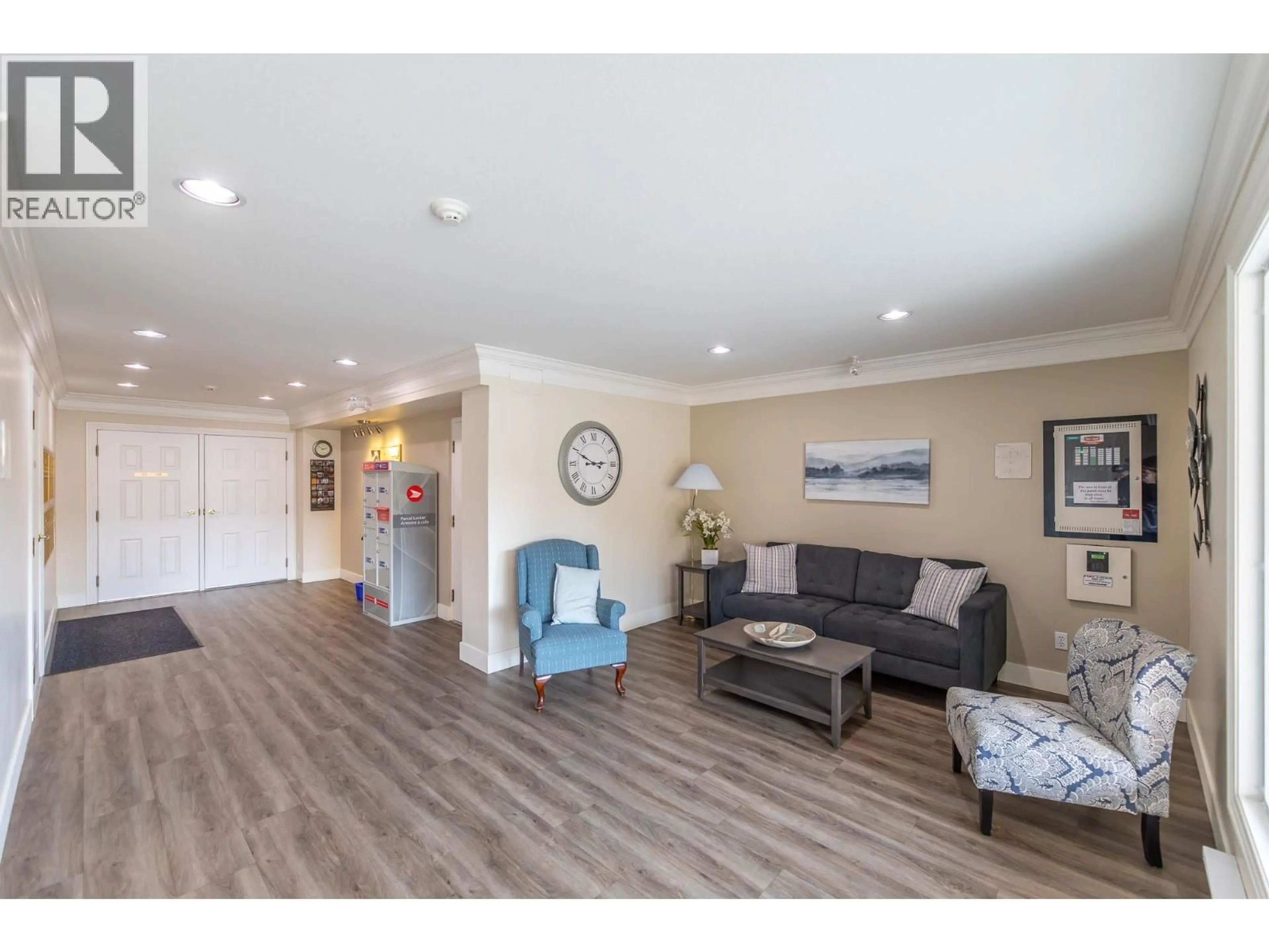 Living room with furniture, wood/laminate floor for 203 - 8700 JUBILEE ROAD EAST, Summerland British Columbia V0H1Z5