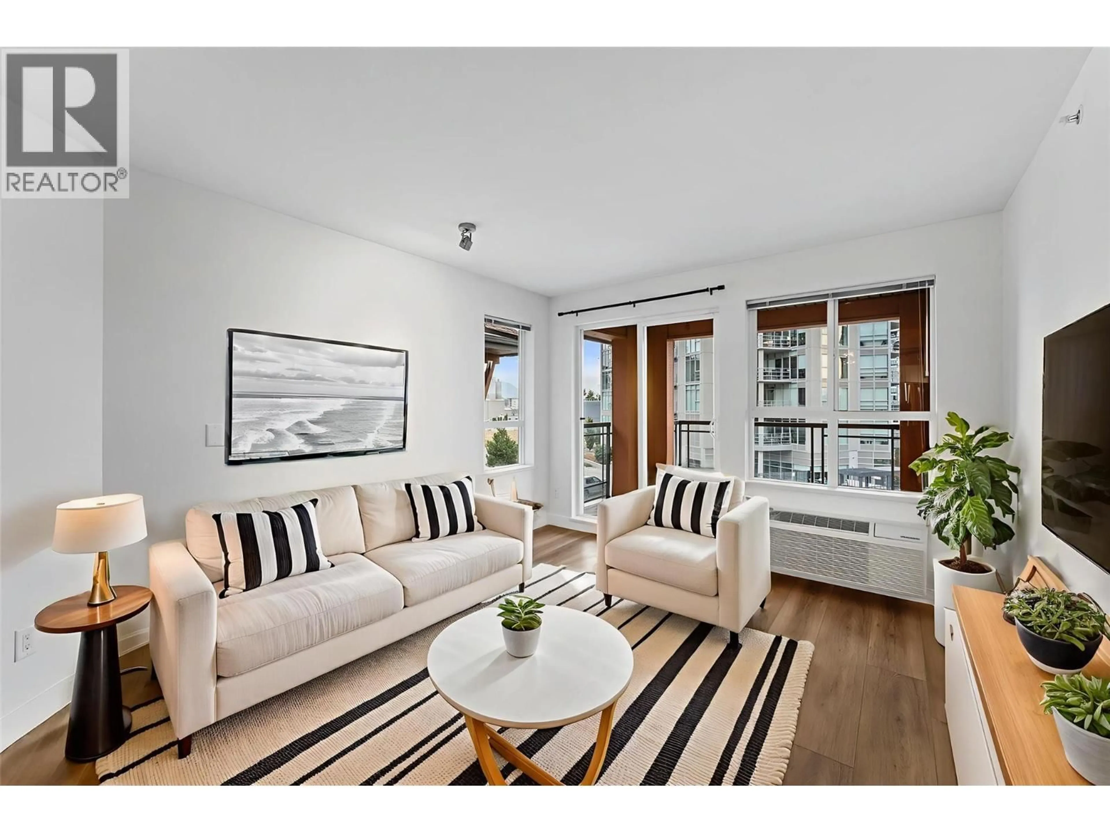 Living room with furniture, wood/laminate floor for 1099 SUNSET DRIVE, Kelowna British Columbia V1Y9Z2