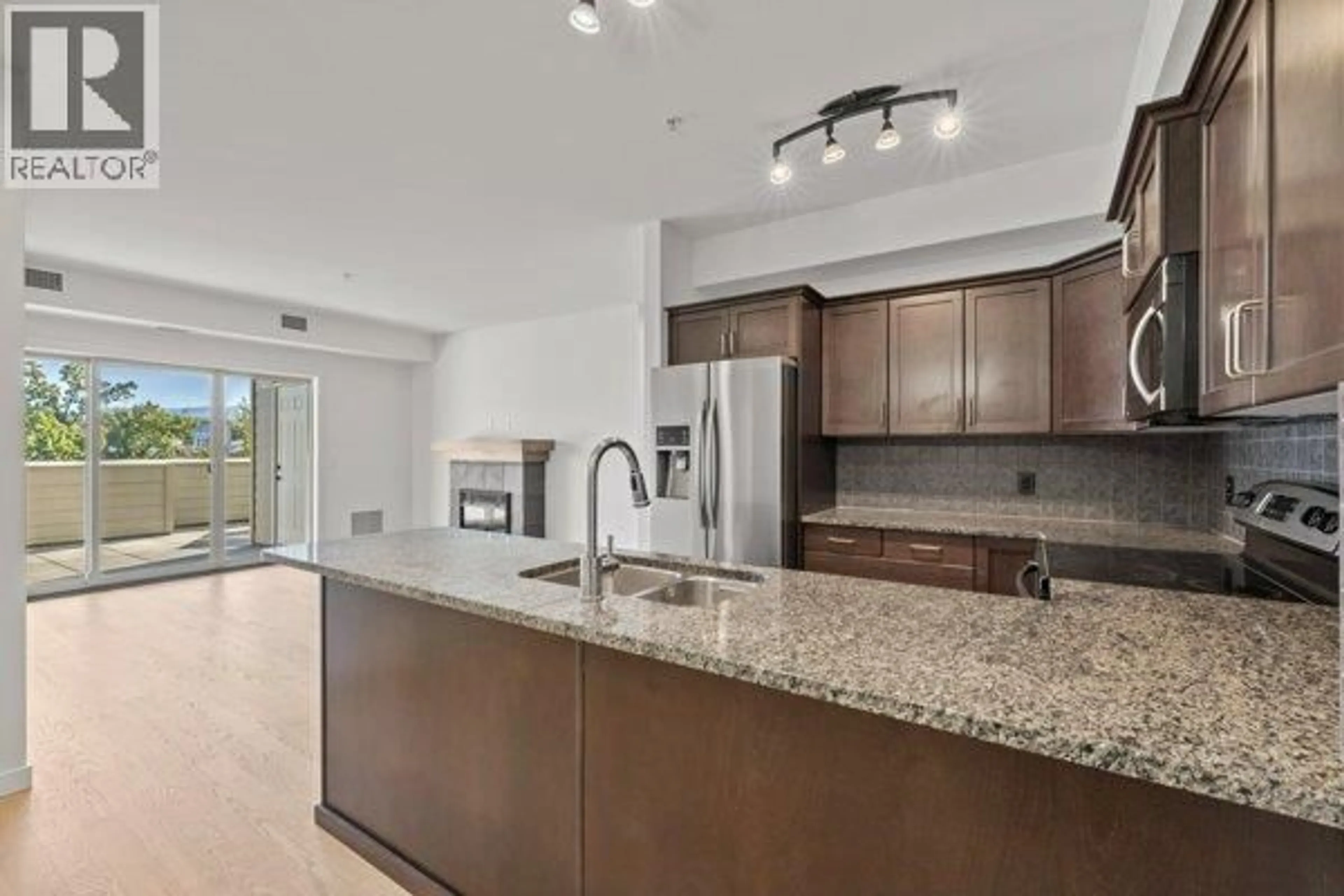 Open concept kitchen, ceramic/tile floor for 201 - 2142 VASILE ROAD, Kelowna British Columbia V1Y6H5
