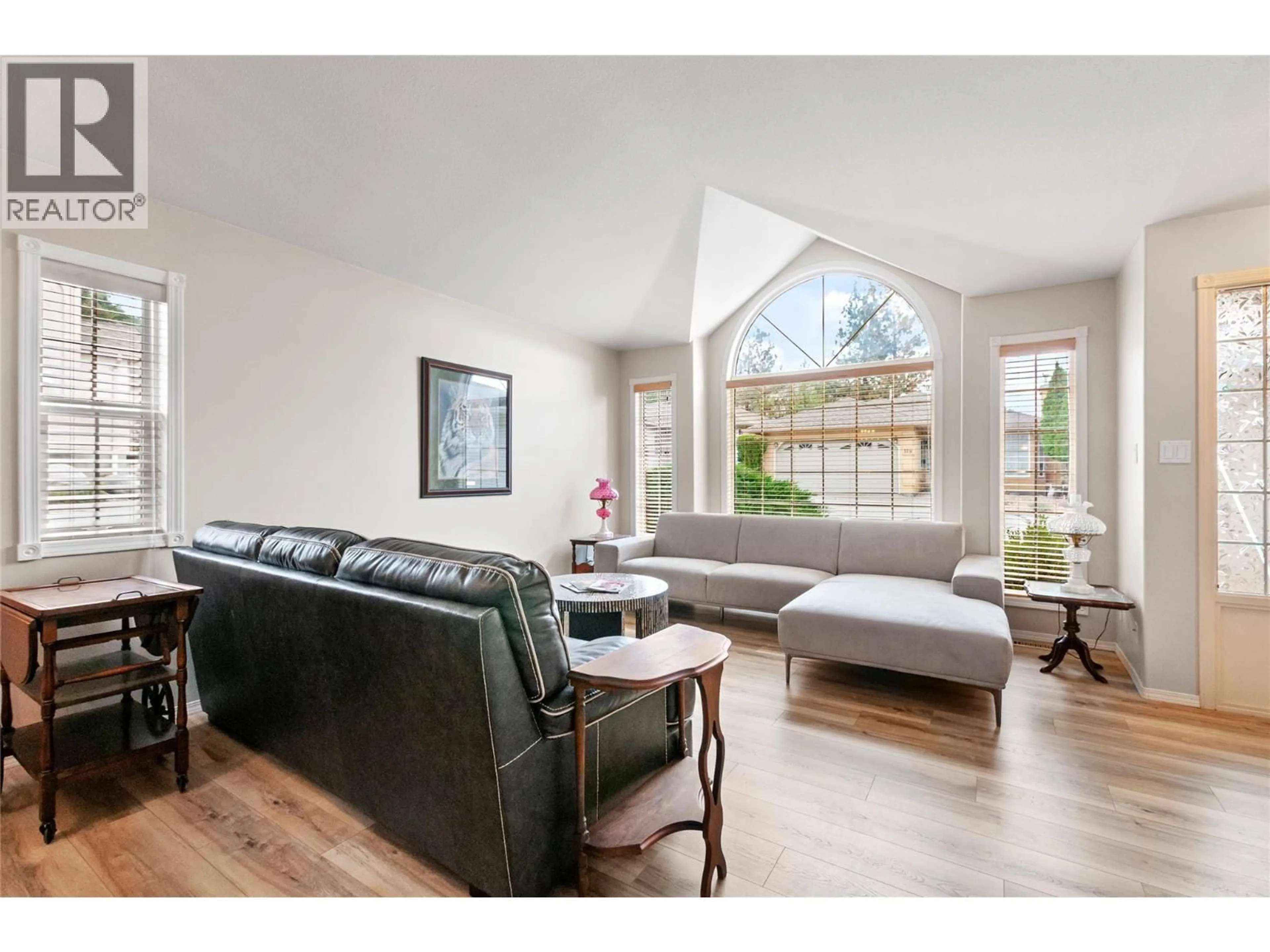 Living room with furniture, wood/laminate floor for 120 - 1634 CARMI AVENUE, Penticton British Columbia V2A8K5
