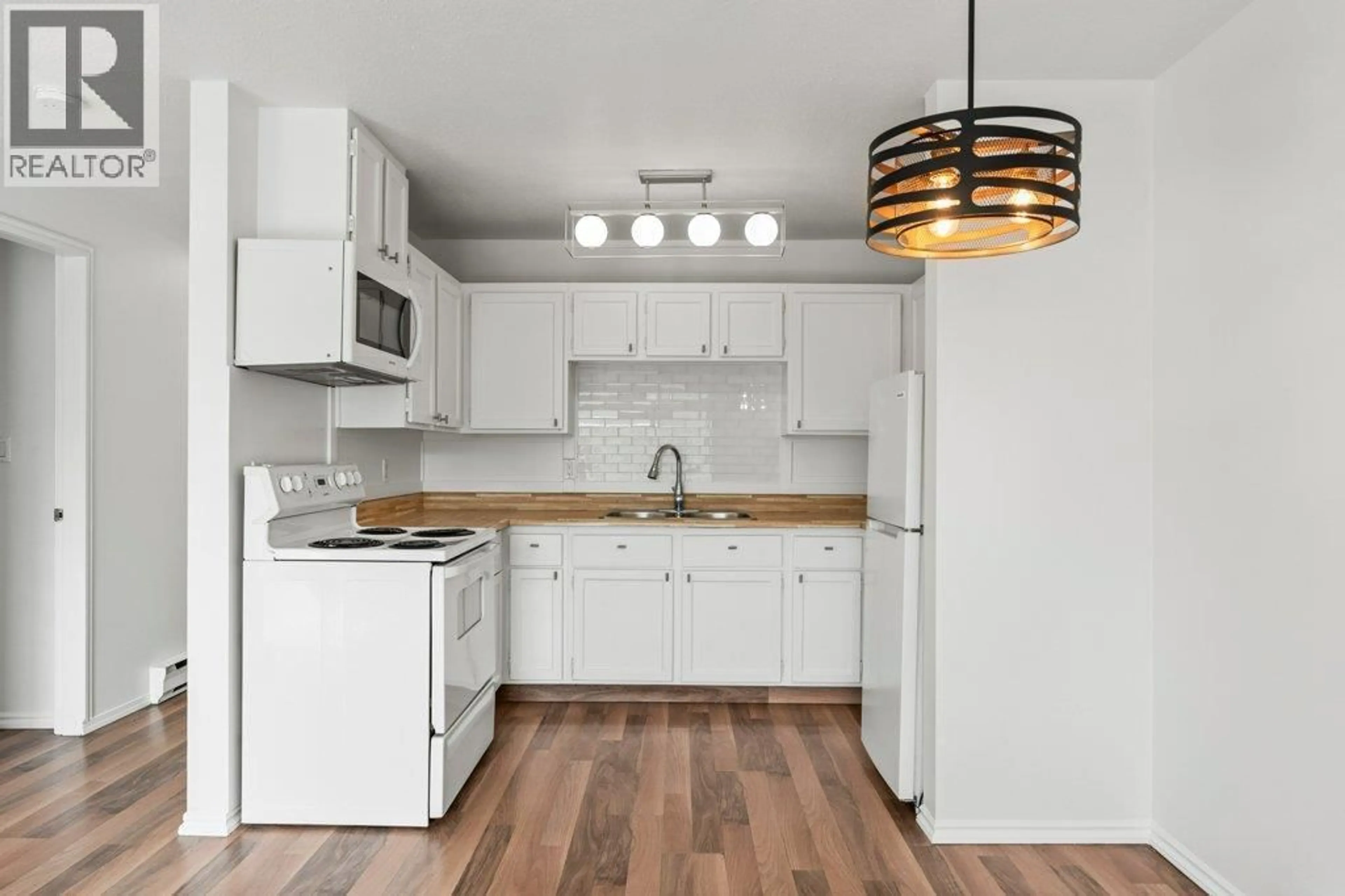 Standard kitchen, wood/laminate floor for 318 - 3304 35 AVENUE, Vernon British Columbia V1T8M6