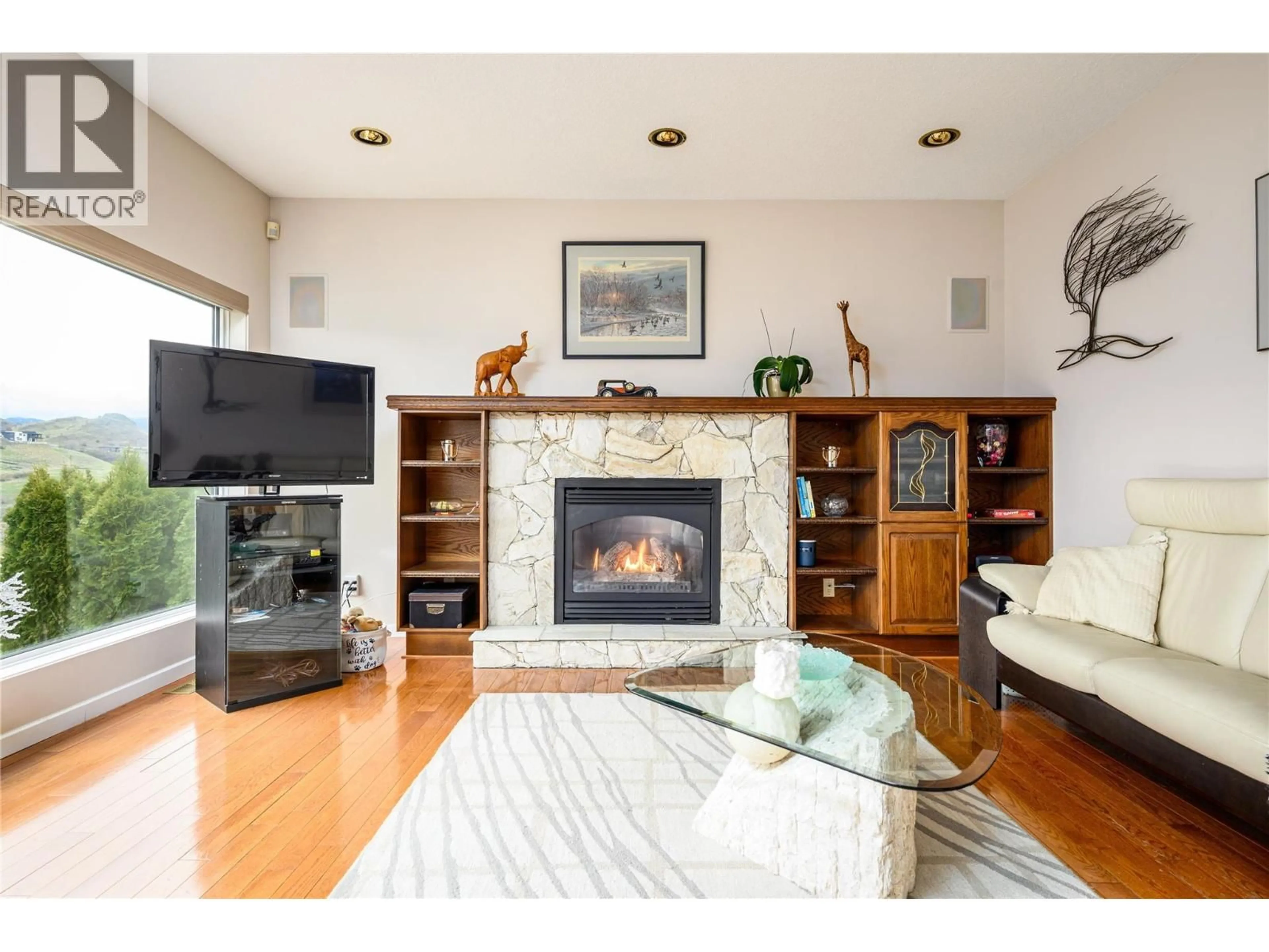 Living room with furniture, wood/laminate floor for 305 COUNTRY ESTATE PLACE, Vernon British Columbia V1B2W7