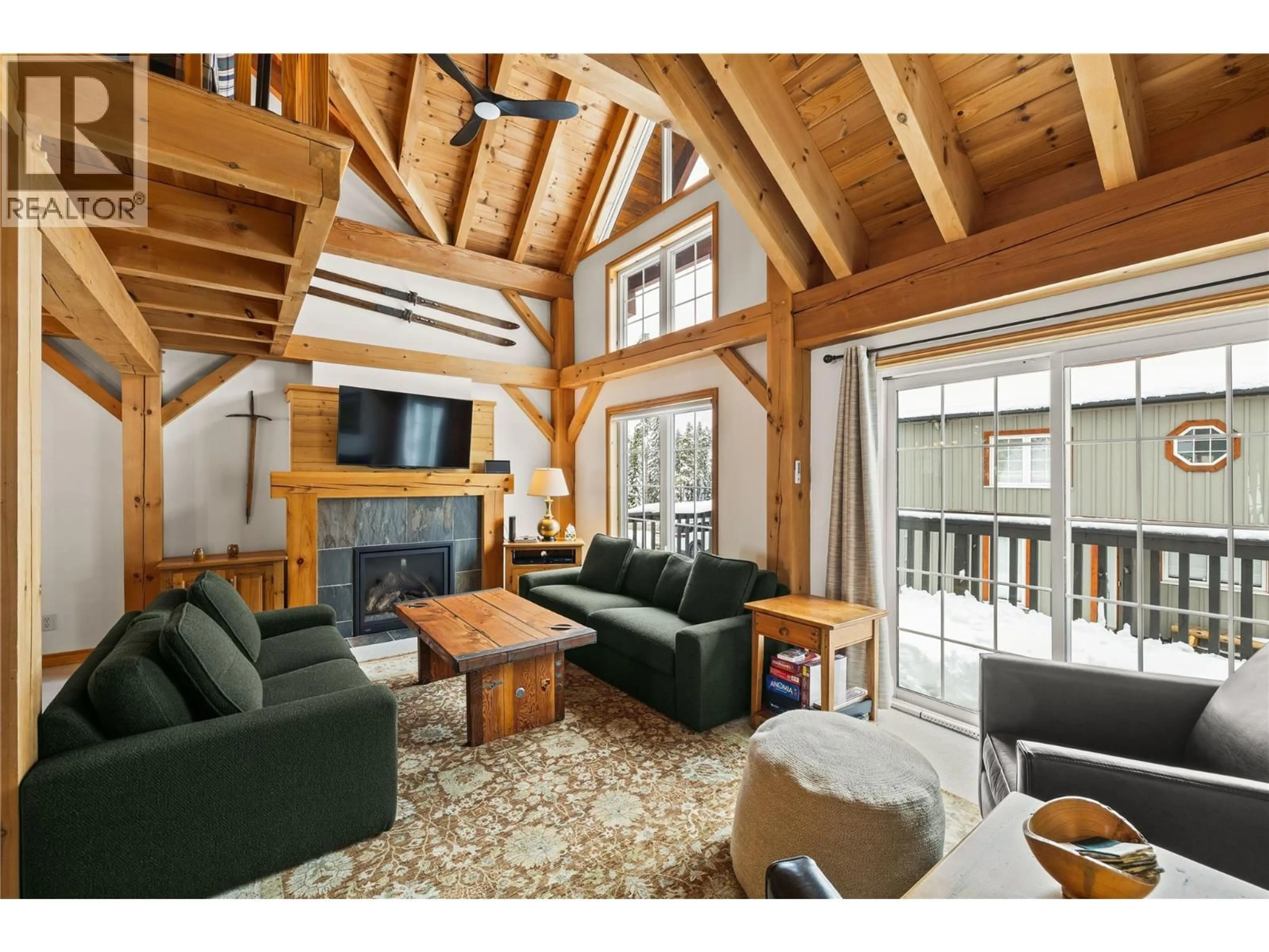 Living room with furniture, wood/laminate floor for 2 - 130 KETTLEVIEW ROAD, Big White British Columbia V1P1P3