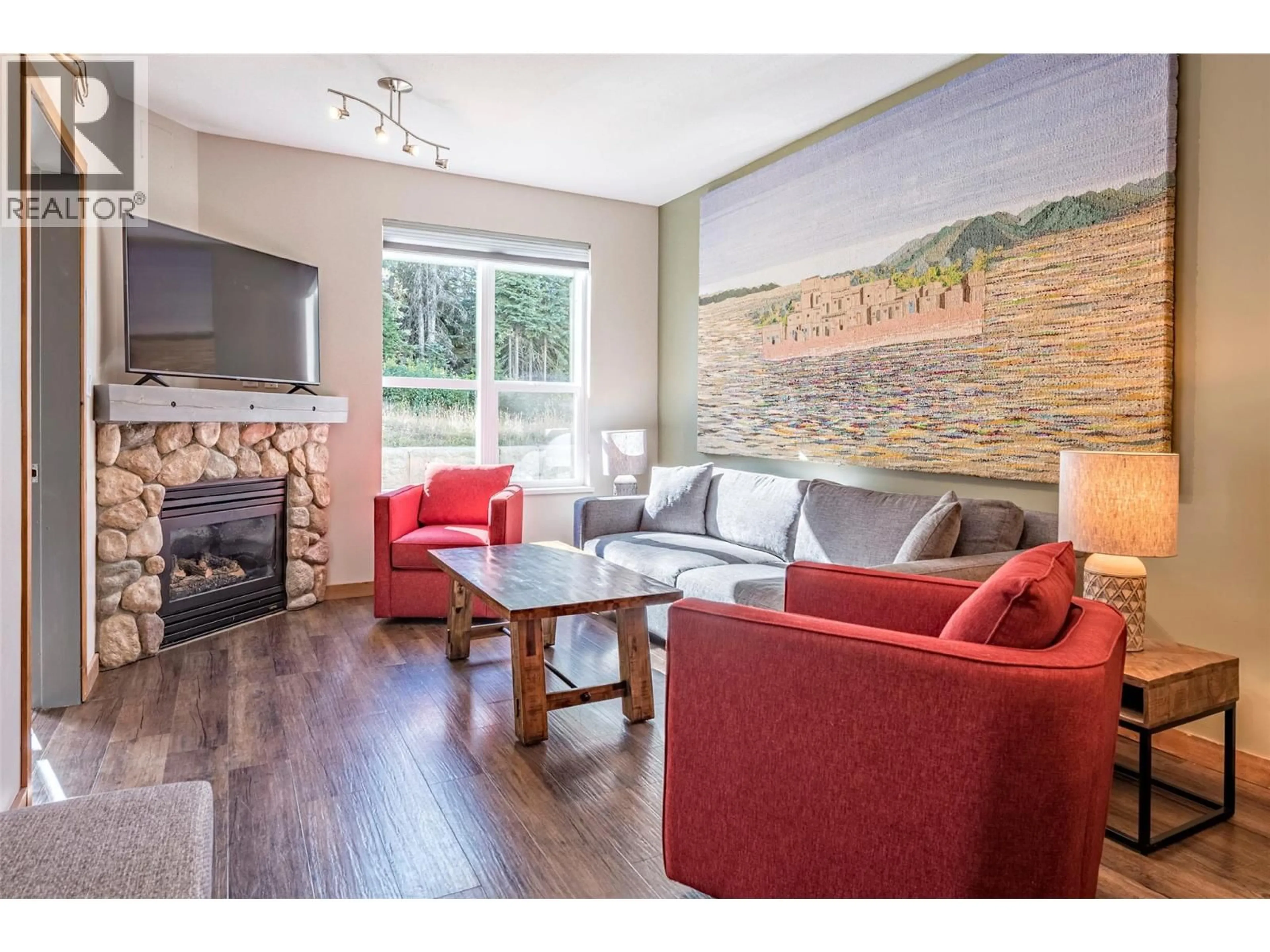 Living room with furniture, wood/laminate floor for 109 - 9808 SILVER STAR ROAD, Vernon British Columbia V1B3X4