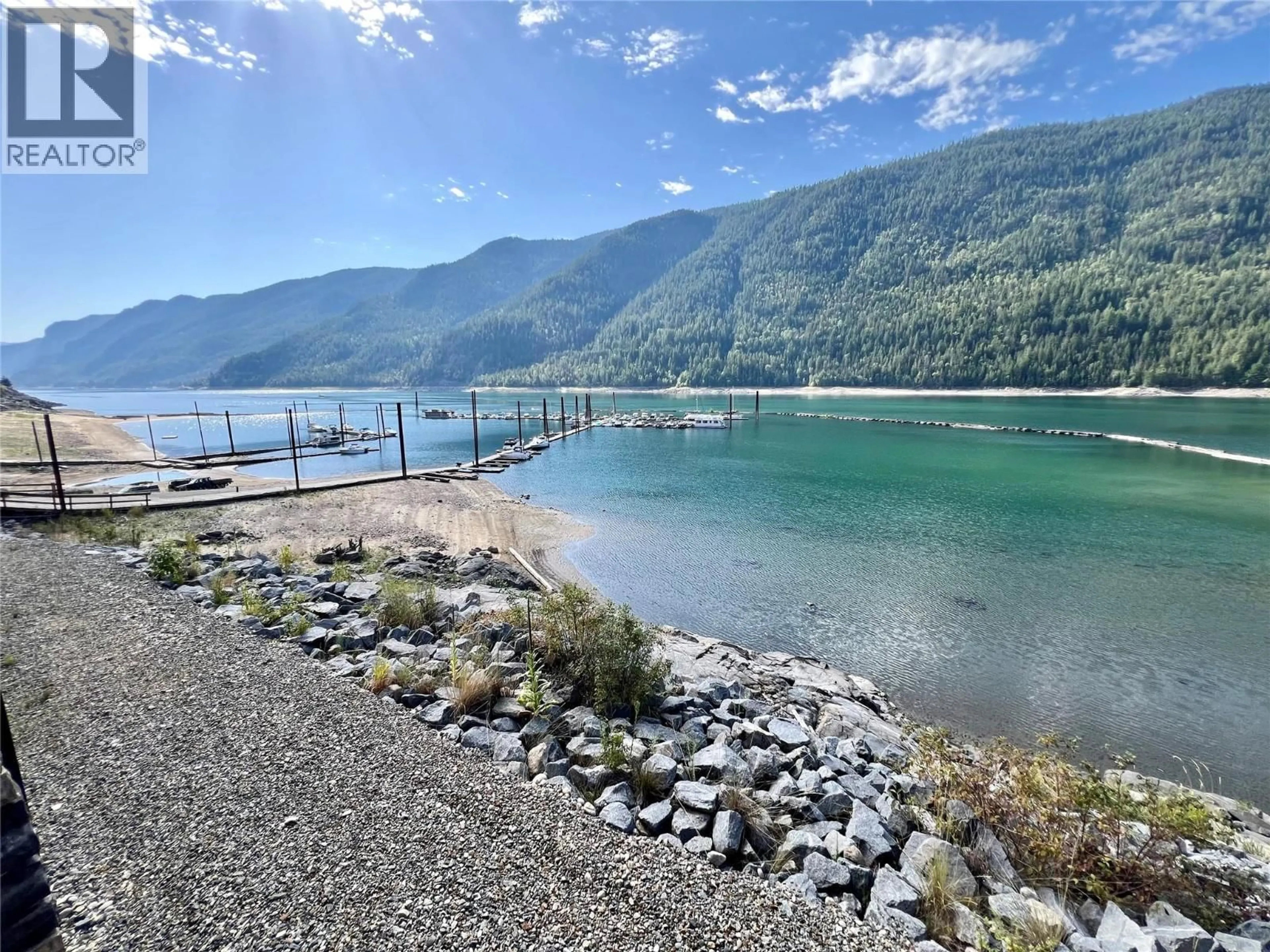 A pic from outside/outdoor area/front of a property/back of a property/a pic from drone, water/lake/river/ocean view for 113 - 5570 BROADWATER ROAD, Castlegar British Columbia V1N0A1