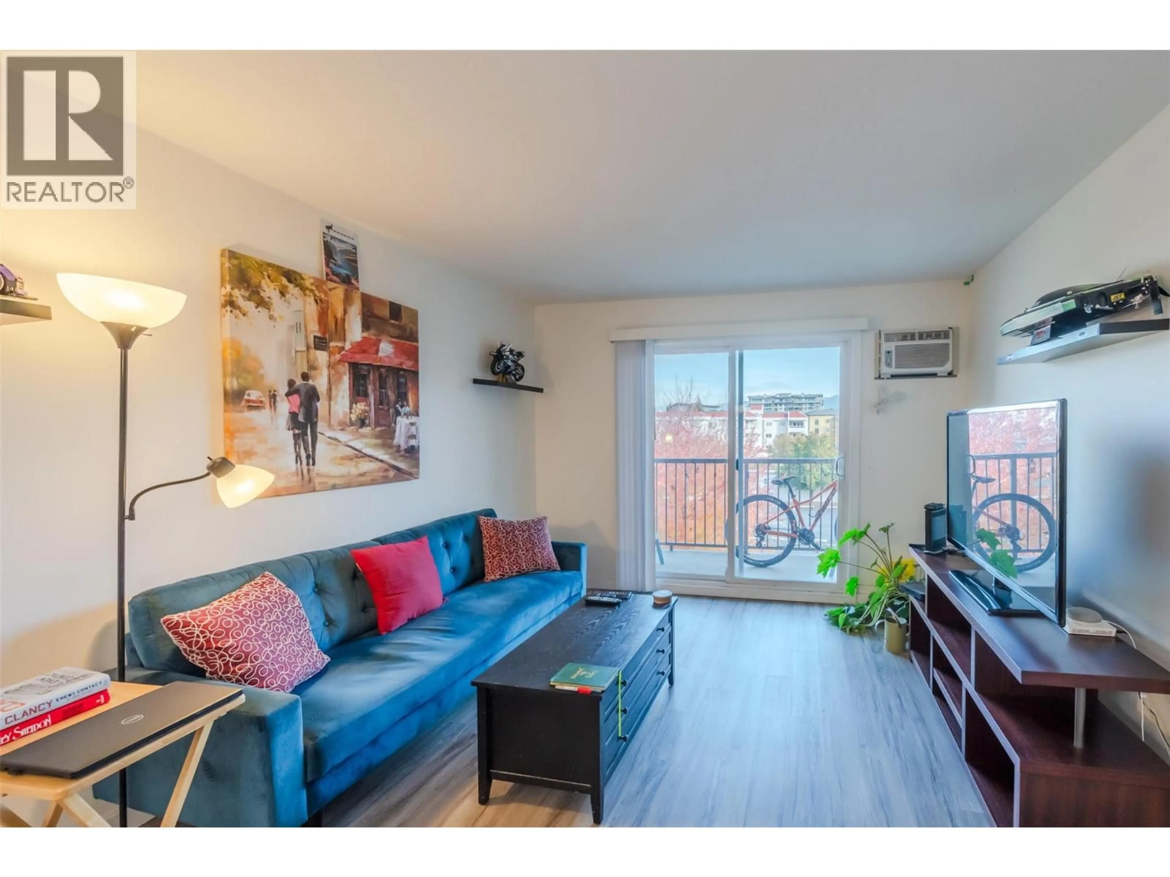 Living room with furniture, wood/laminate floor for 411 - 130 SKAHA PLACE, Penticton British Columbia V2A7J6