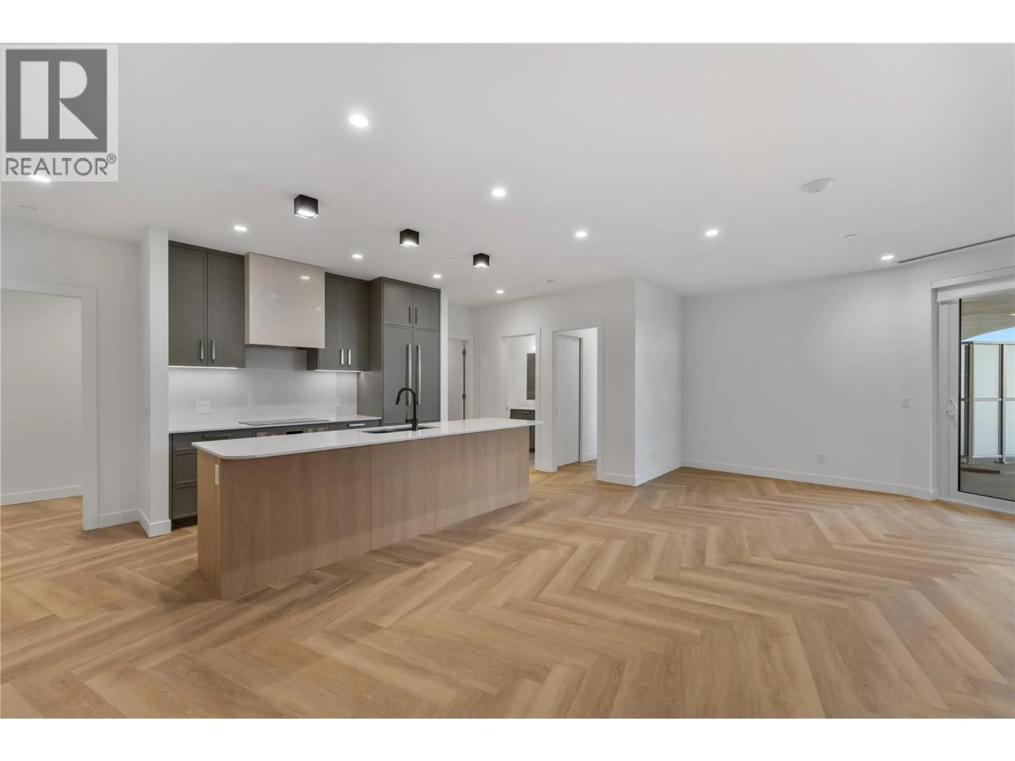 Open concept kitchen, wood/laminate floor for 414 - 3340 LAKESHORE DRIVE, Kelowna British Columbia V1W0H6