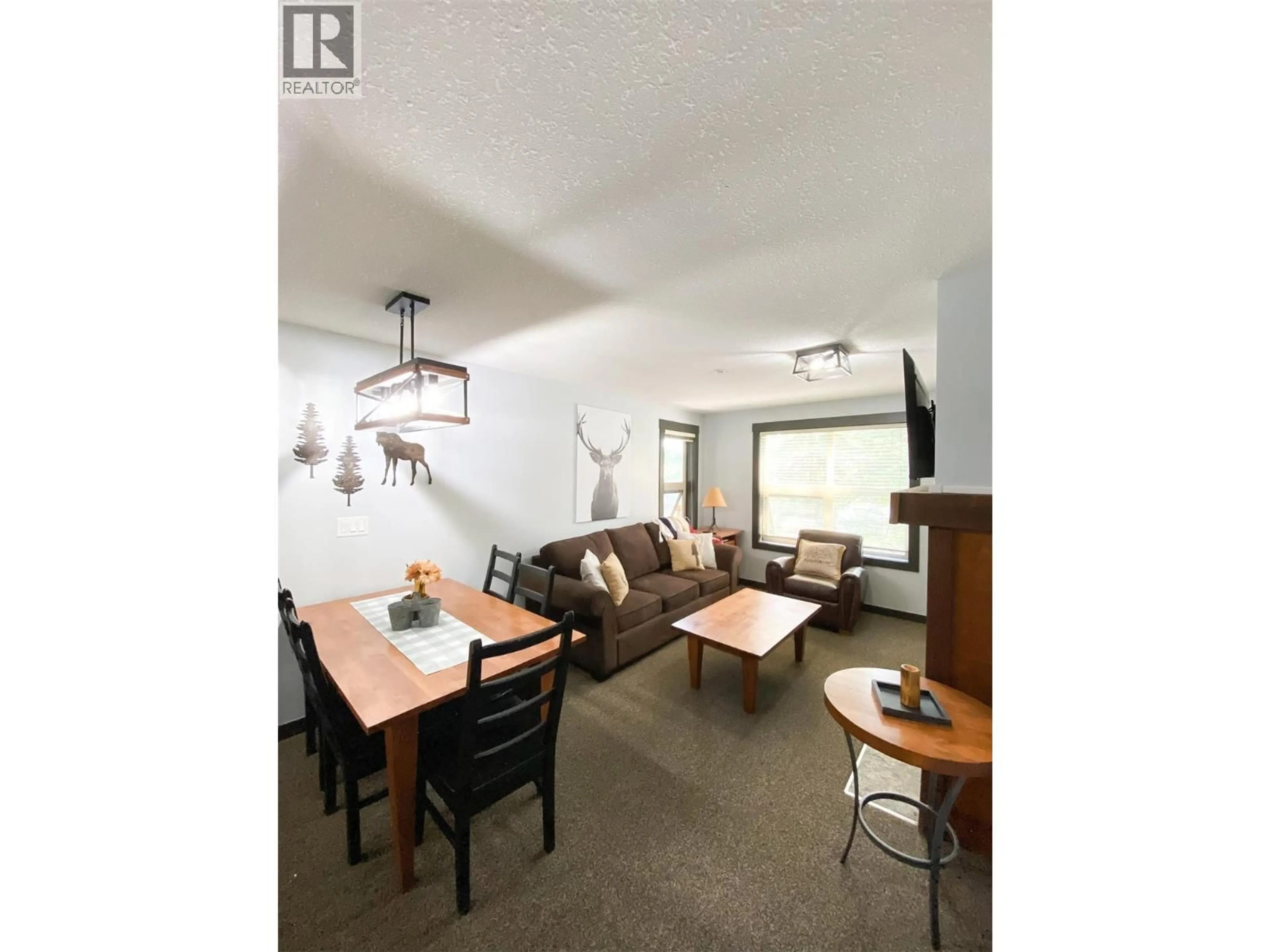 Living room with furniture, wood/laminate floor for 306 - 2070 SUMMIT DRIVE DRIVE, Panorama British Columbia V0A1T0