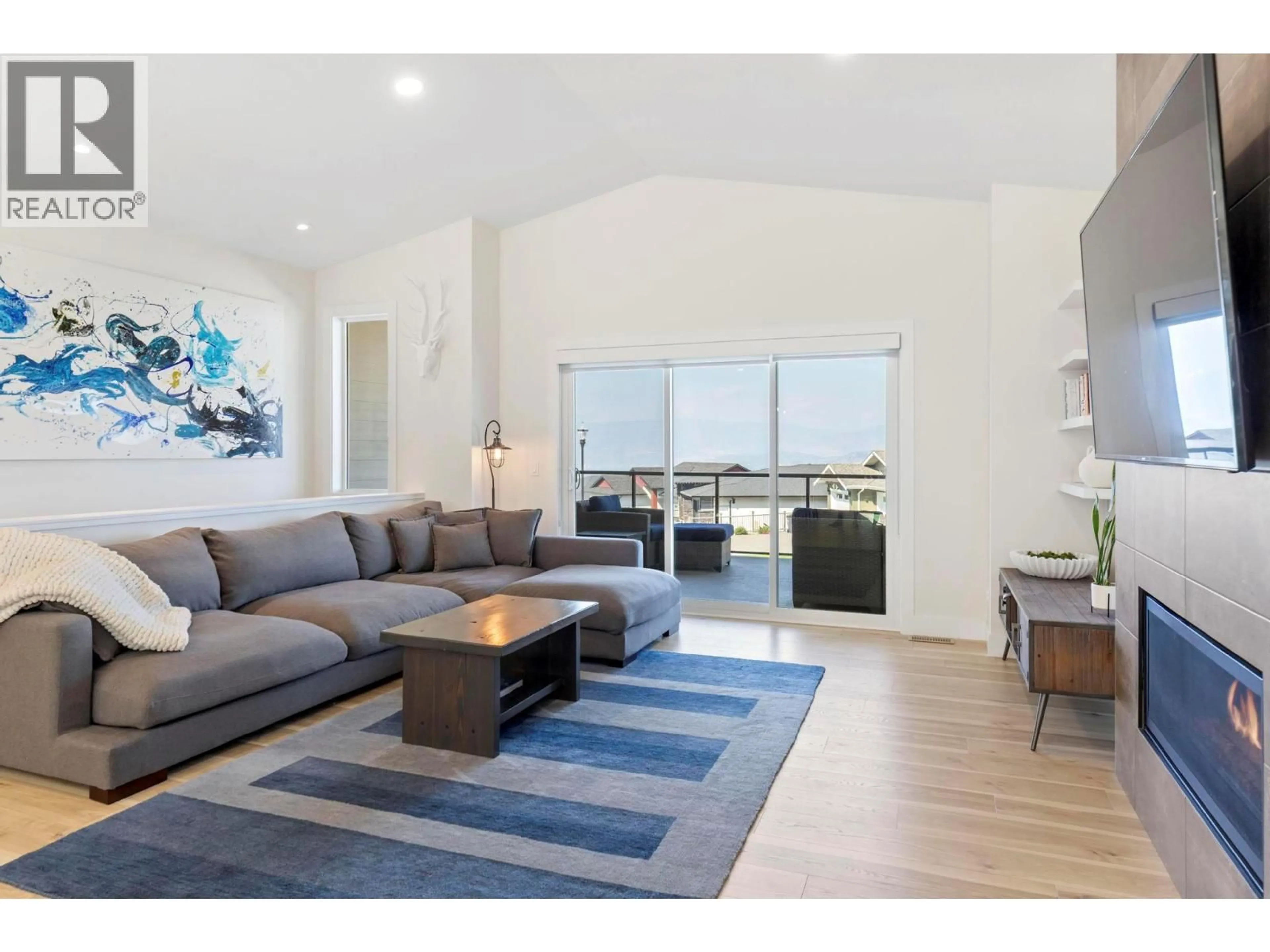 Living room with furniture, wood/laminate floor for 2209 LAVETTA DRIVE, Kelowna British Columbia V1P1V1
