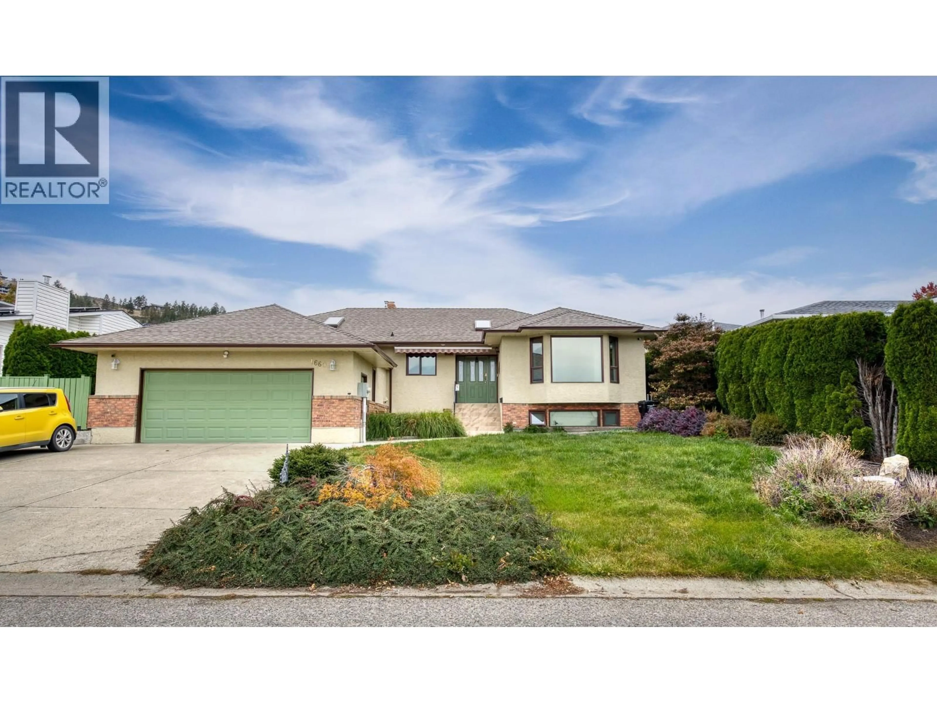 Home with vinyl exterior material, street for 1660 SONORA DRIVE, Kelowna British Columbia V1Y8Z1