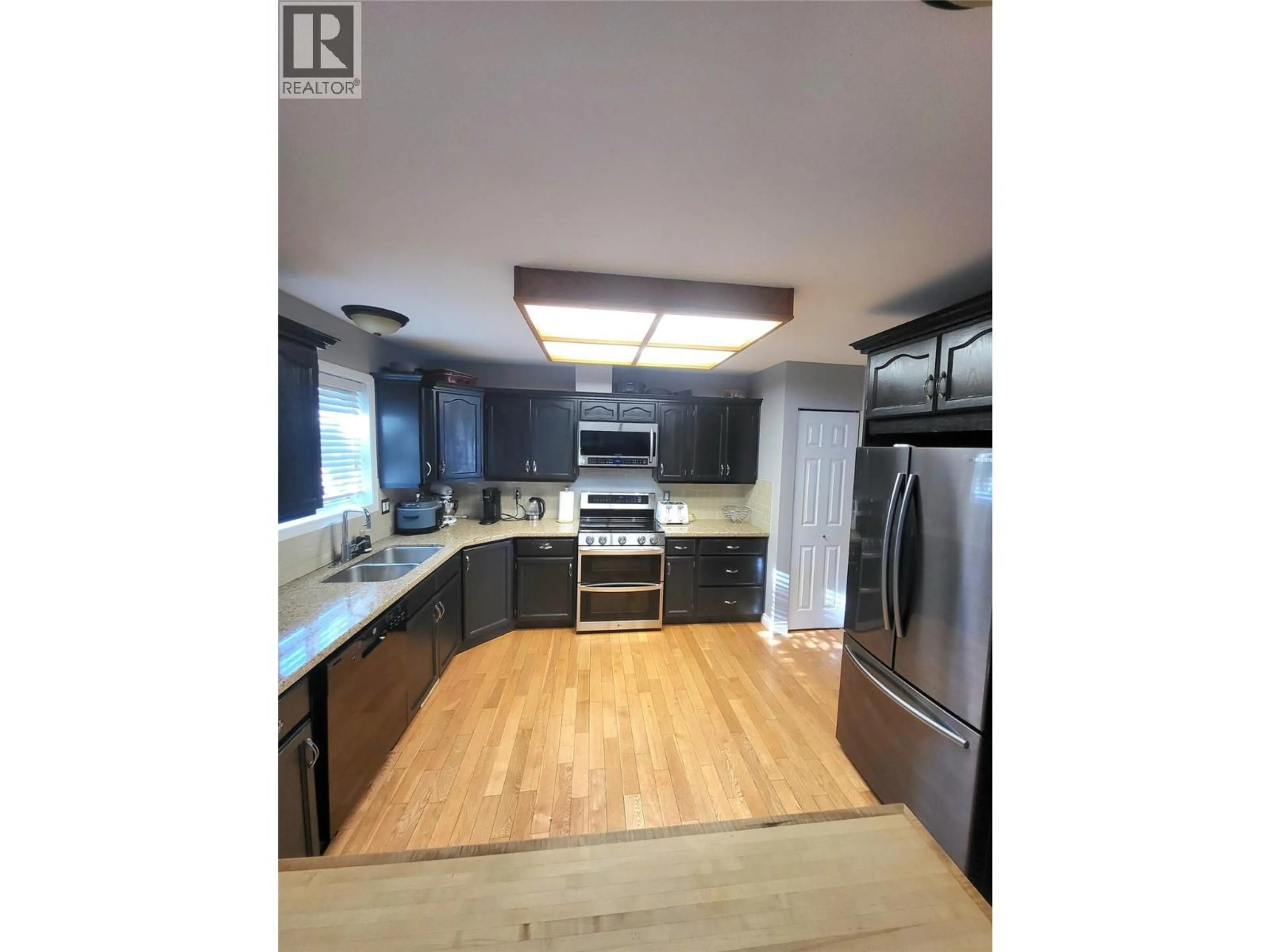 Open concept kitchen, wood/laminate floor for 132 STEVENS COURT, Penticton British Columbia V2A8A2