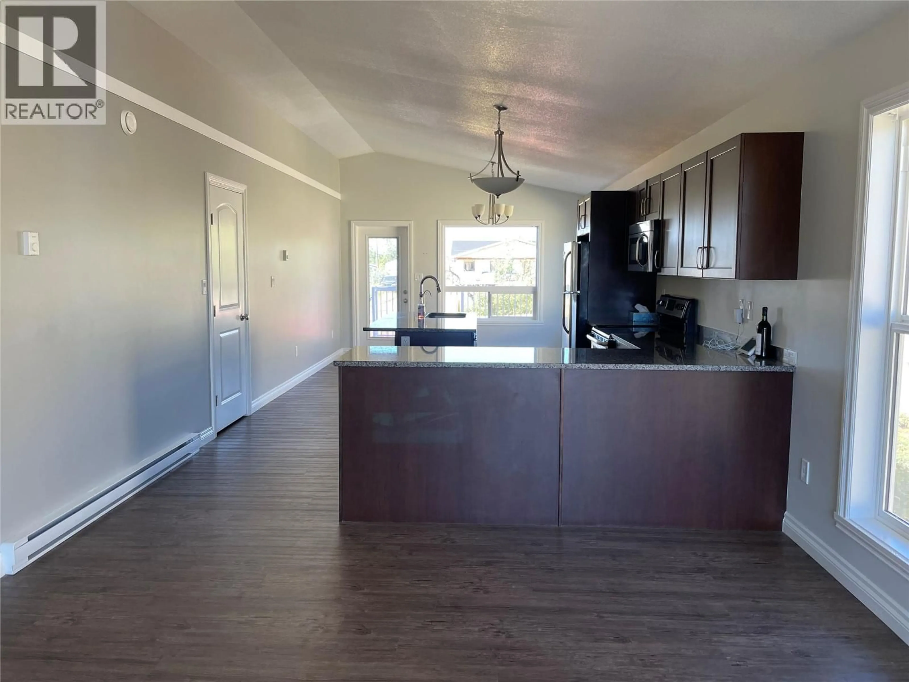 Open concept kitchen, wood/laminate floor for 1712 82 AVENUE, Dawson Creek British Columbia V1G0H9
