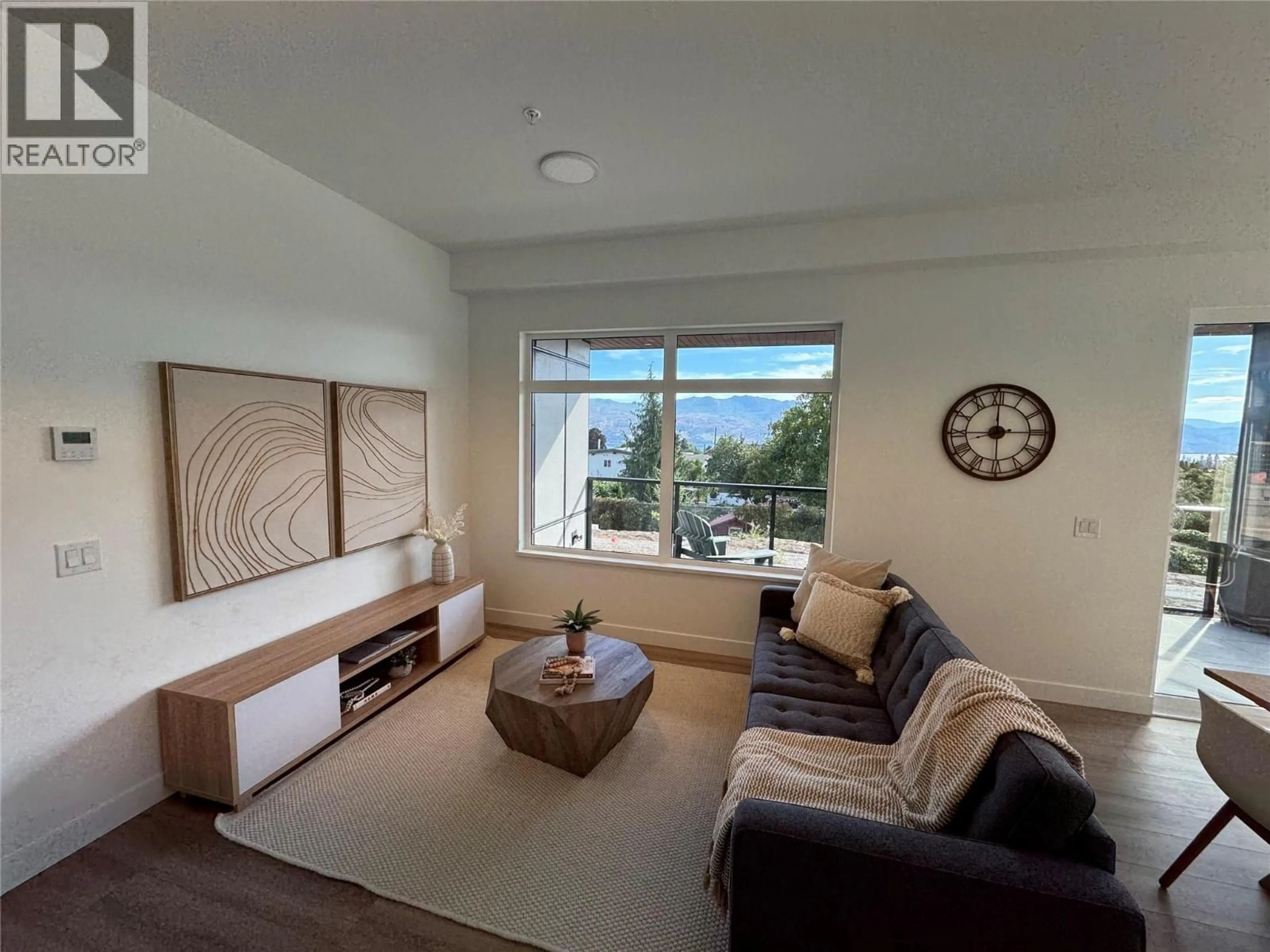 Living room with furniture, wood/laminate floor for 105 - 2780 OLALLA BAY, West Kelowna British Columbia V1Z2A9