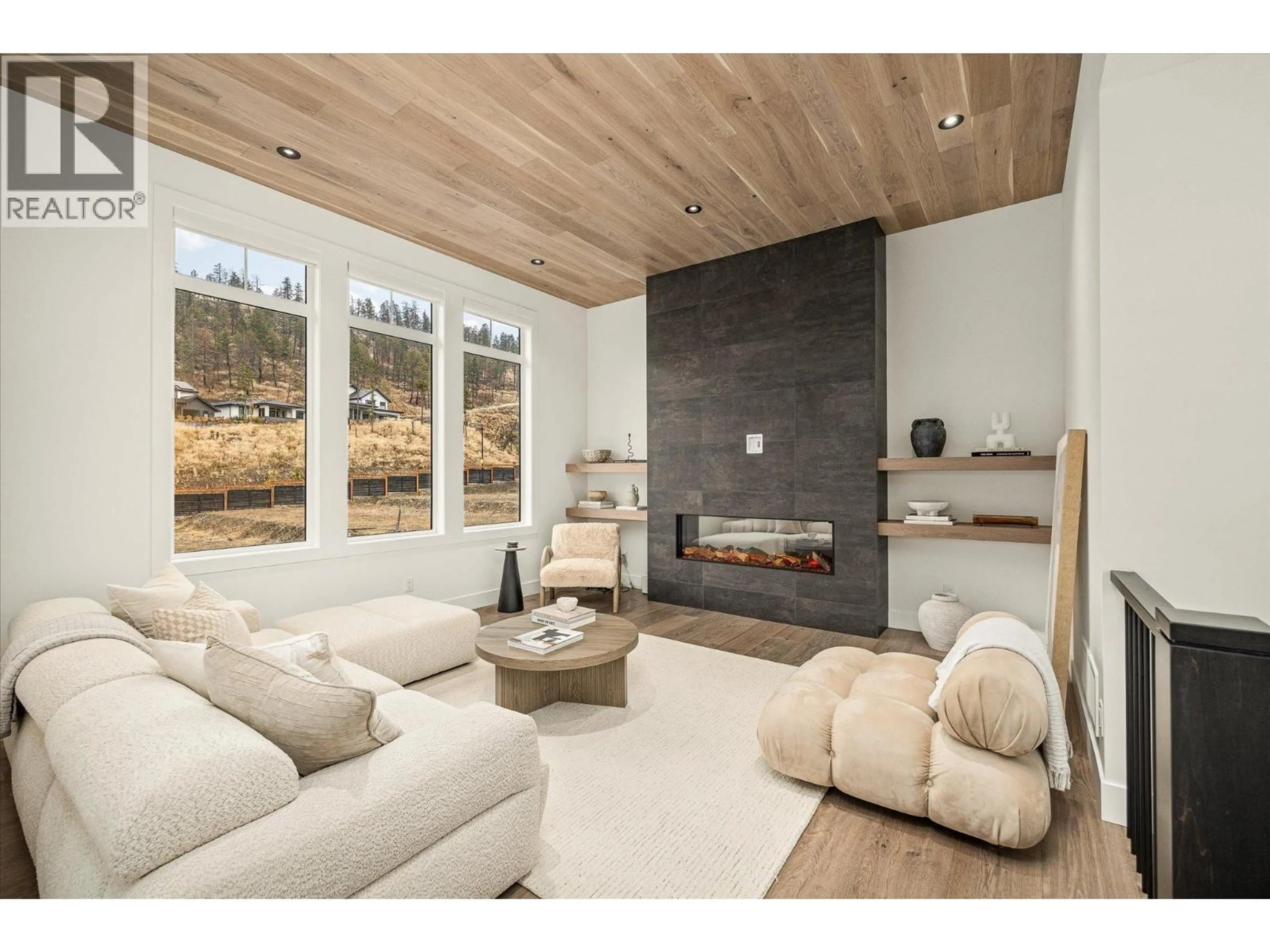 Living room with furniture, wood/laminate floor for 1437 APRIL SPRINGS COURT, Kelowna British Columbia V1V2C6