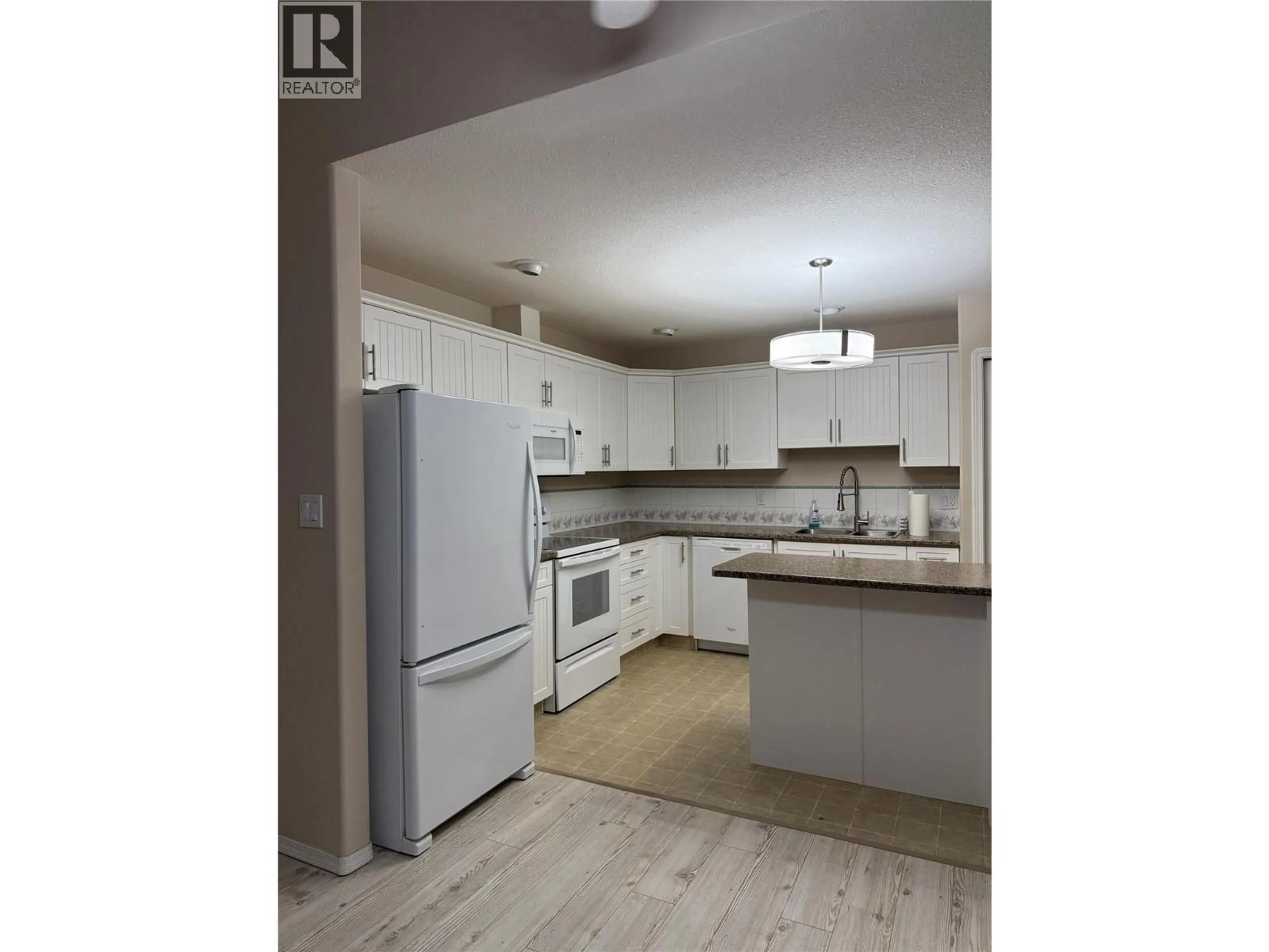 Open concept kitchen, wood/laminate floor for 11 - 501 KILDONAN AVENUE, Enderby British Columbia V0E1V2
