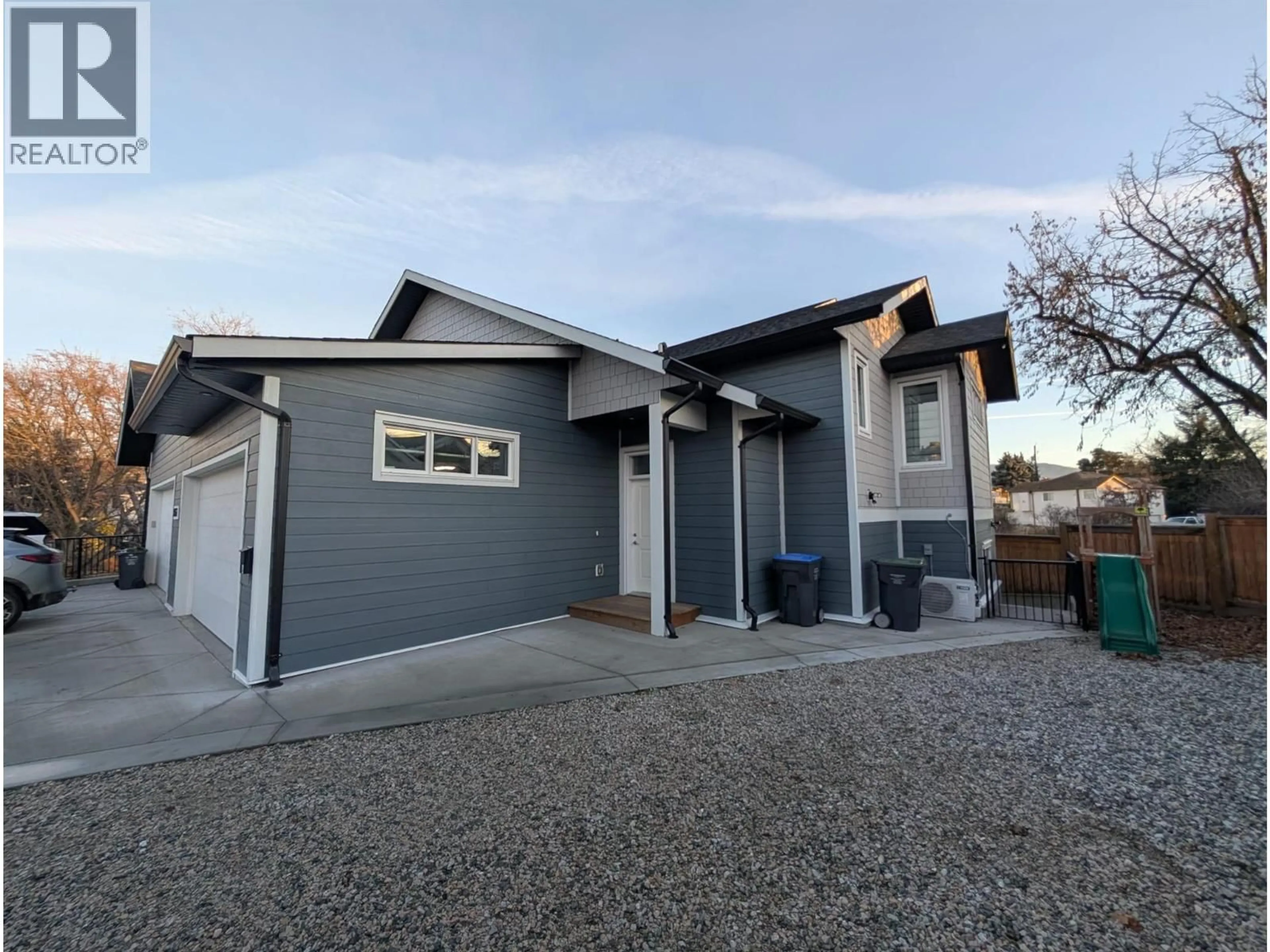 Home with vinyl exterior material, street for 1347 A&B ORCHARD DRIVE, Kelowna British Columbia V1Y3V1