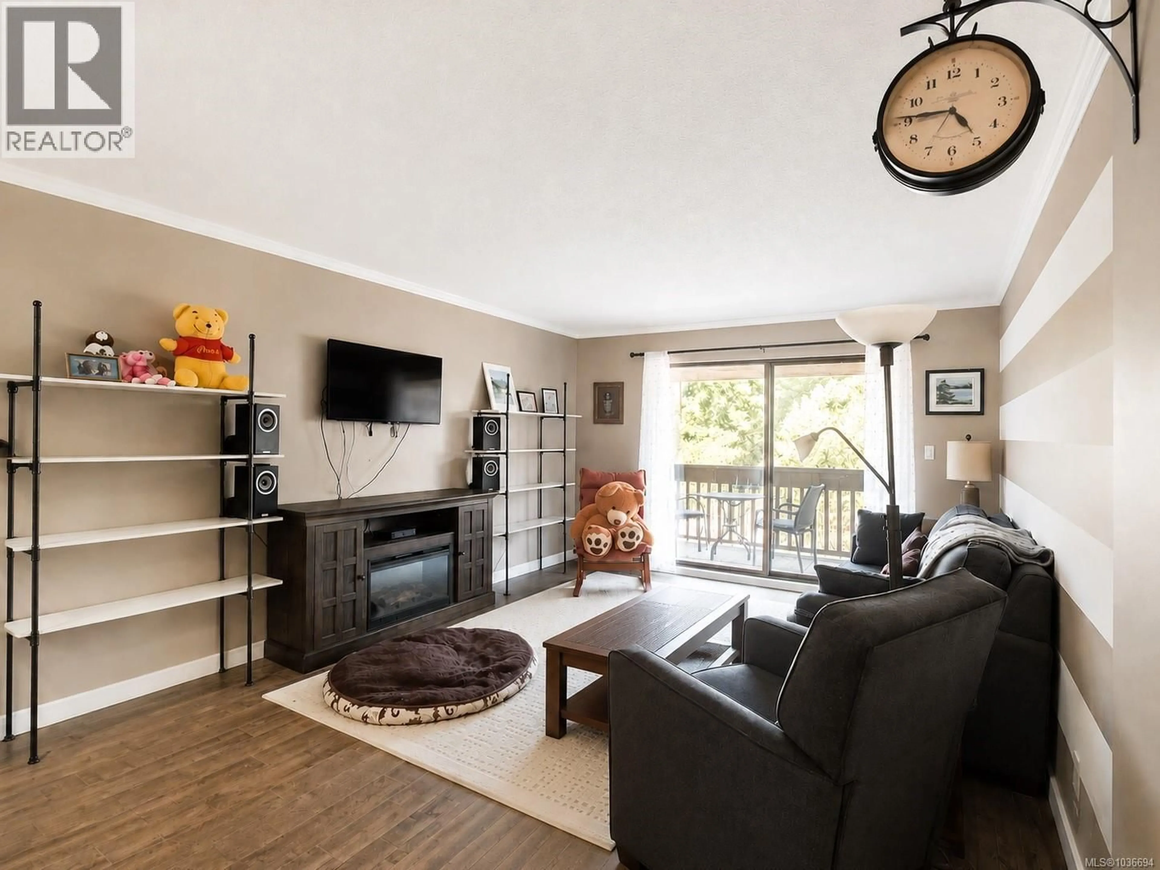 Living room with furniture, wood/laminate floor for 410 - 3277 GLASGOW AVENUE, Saanich British Columbia V8X1M3