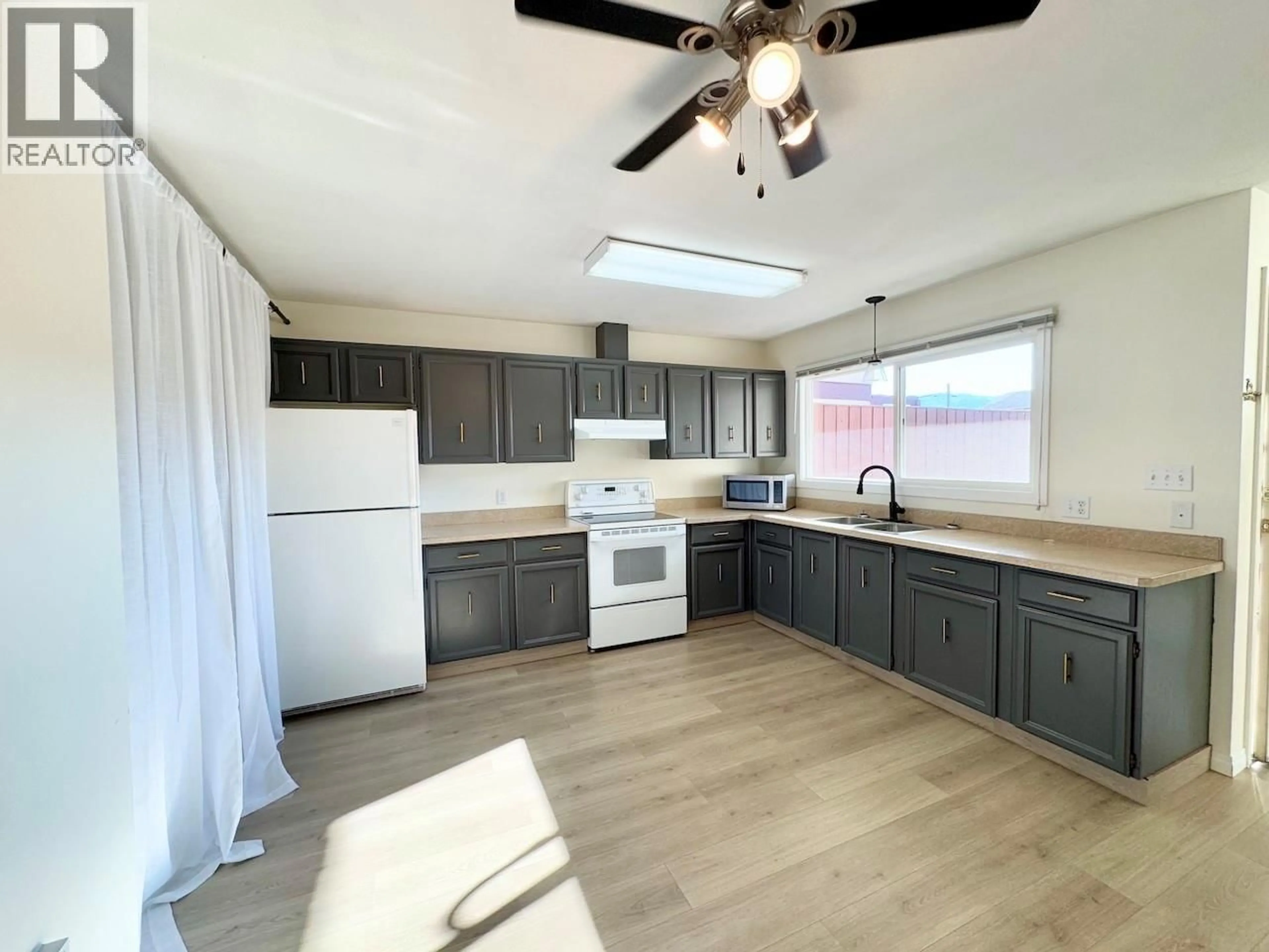 Open concept kitchen, wood/laminate floor for 9 - 5877 MAIN STREET, Oliver British Columbia V0H1T0