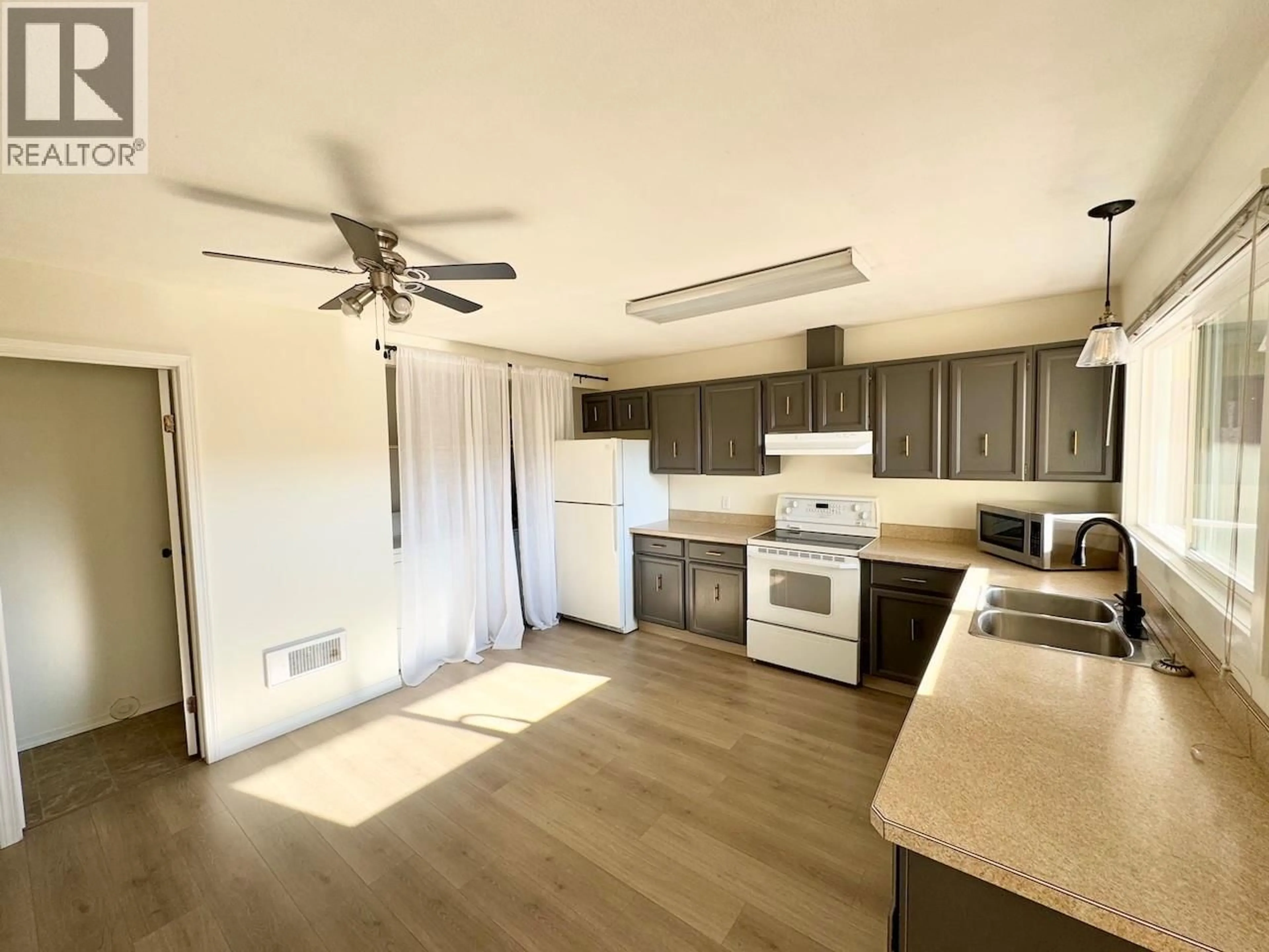 Open concept kitchen, wood/laminate floor for 9 - 5877 MAIN STREET, Oliver British Columbia V0H1T0