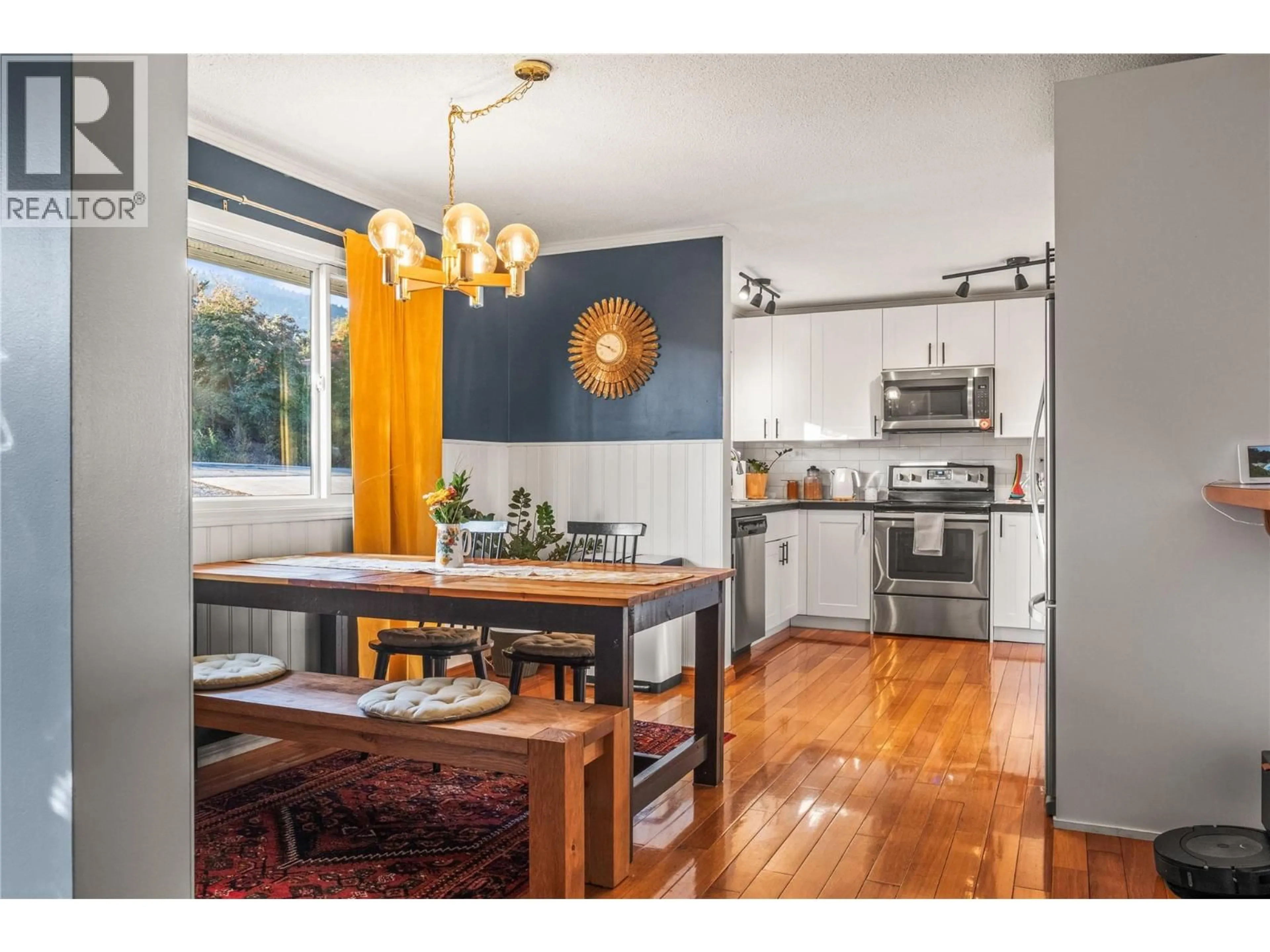 Open concept kitchen, wood/laminate floor for 7089 LONGACRE DRIVE, Vernon British Columbia V1H1H8