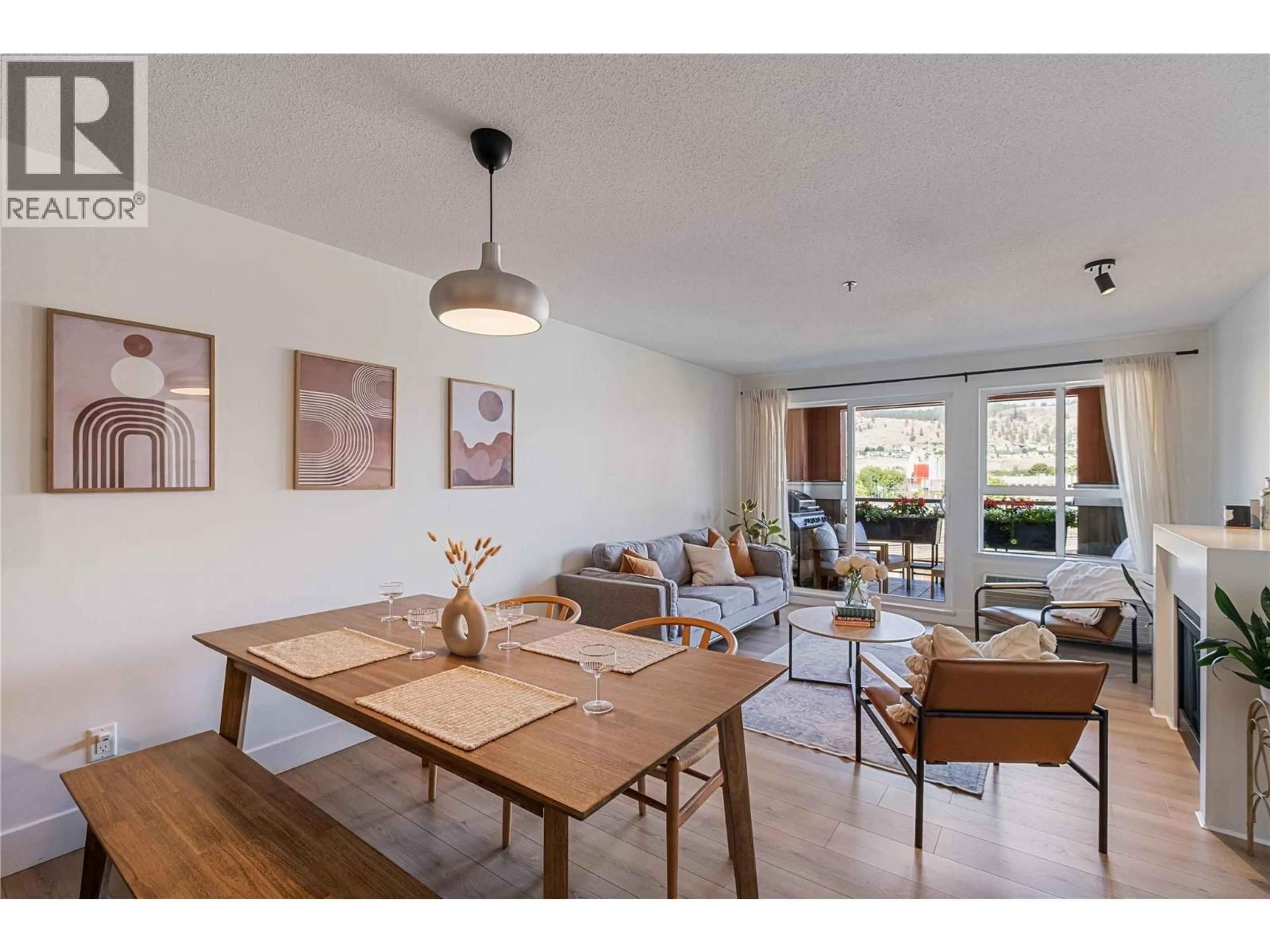 Living room with furniture, wood/laminate floor for 307 - 1093 SUNSET DRIVE, Kelowna British Columbia V1Y9Z4