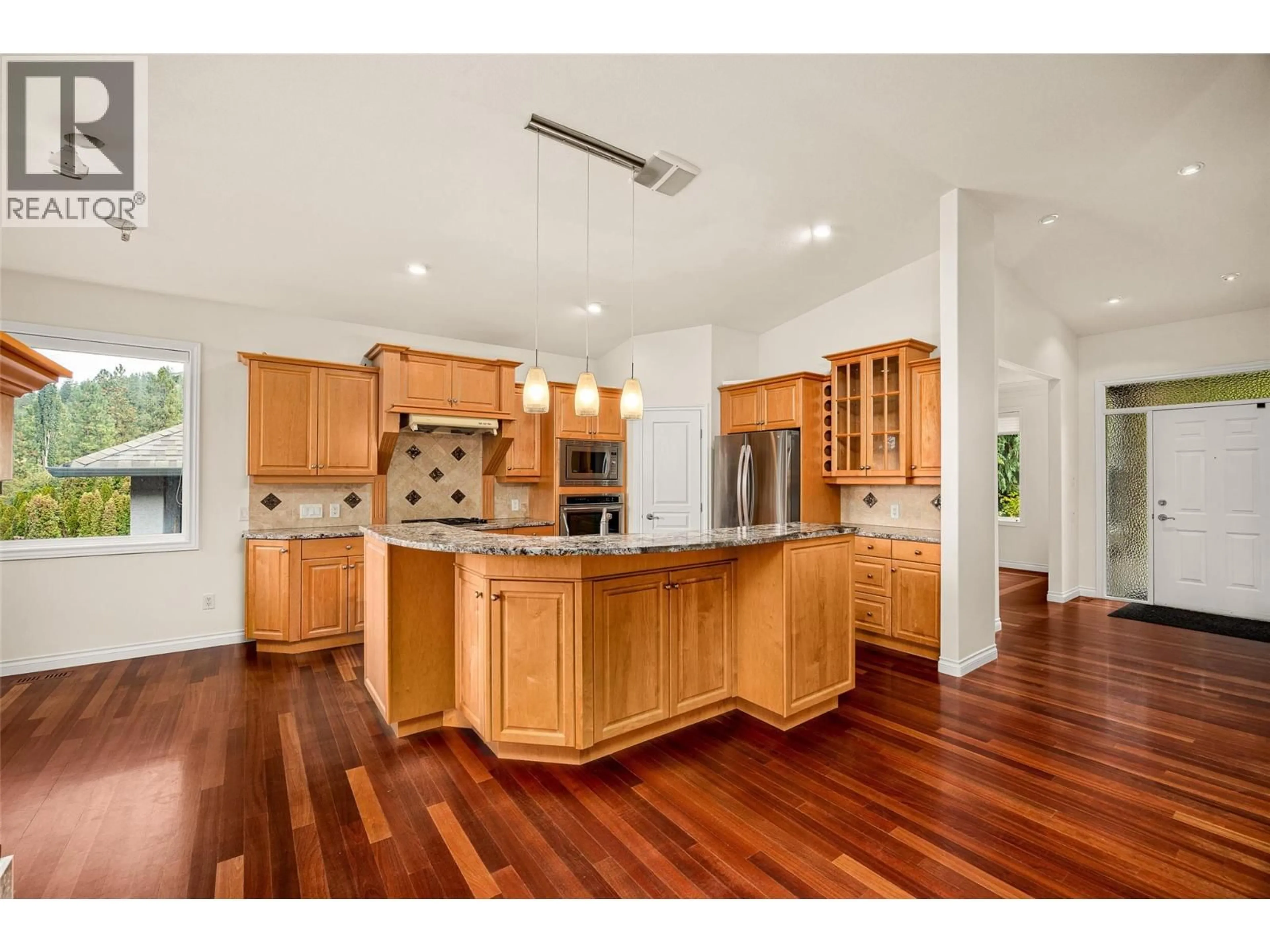 Open concept kitchen, wood/laminate floor for 2090 BOWRON STREET, Kelowna British Columbia V1V2P2