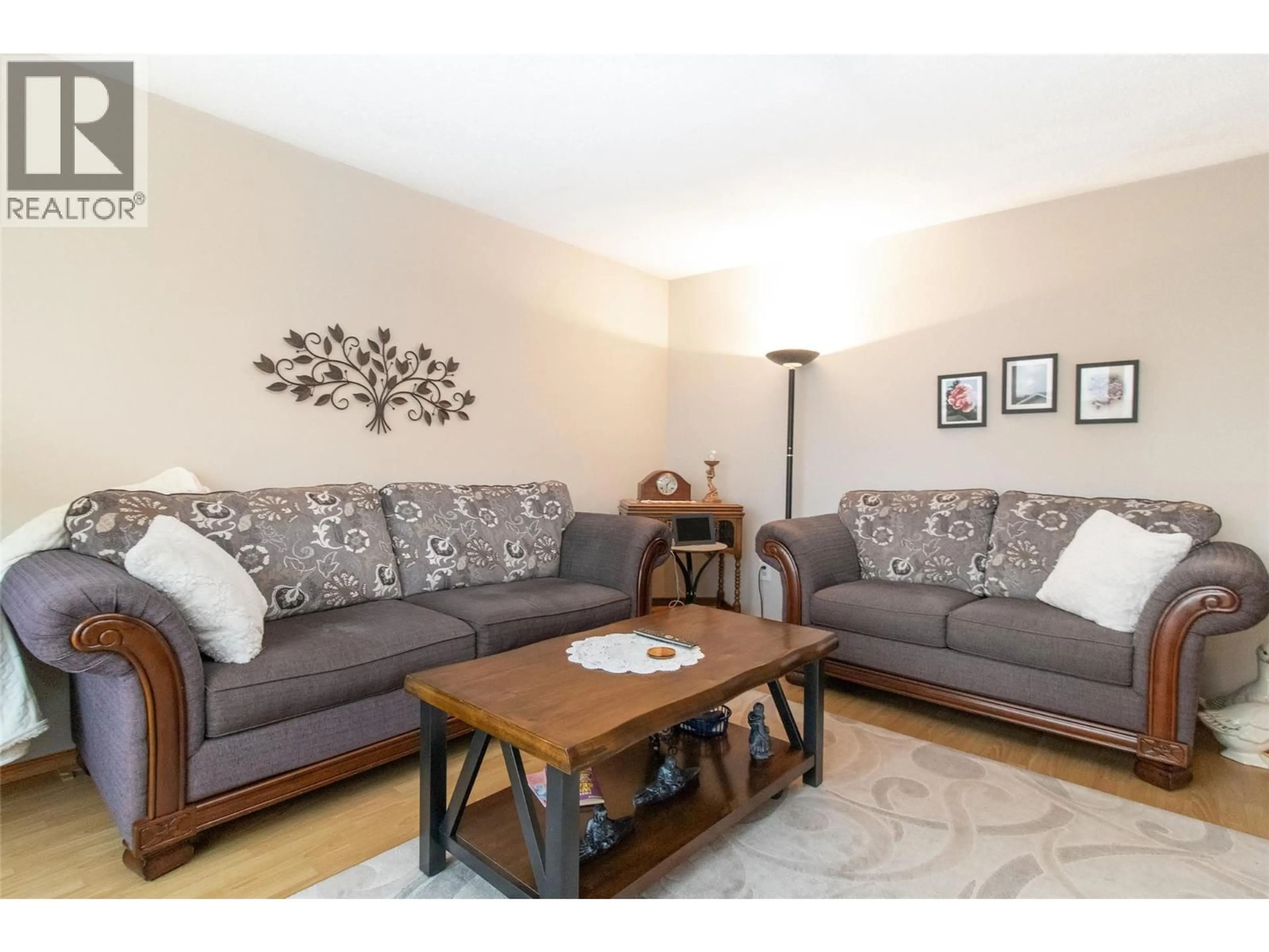 Living room with furniture, wood/laminate floor for 595 BACH ROAD, Kelowna British Columbia V1X6C9