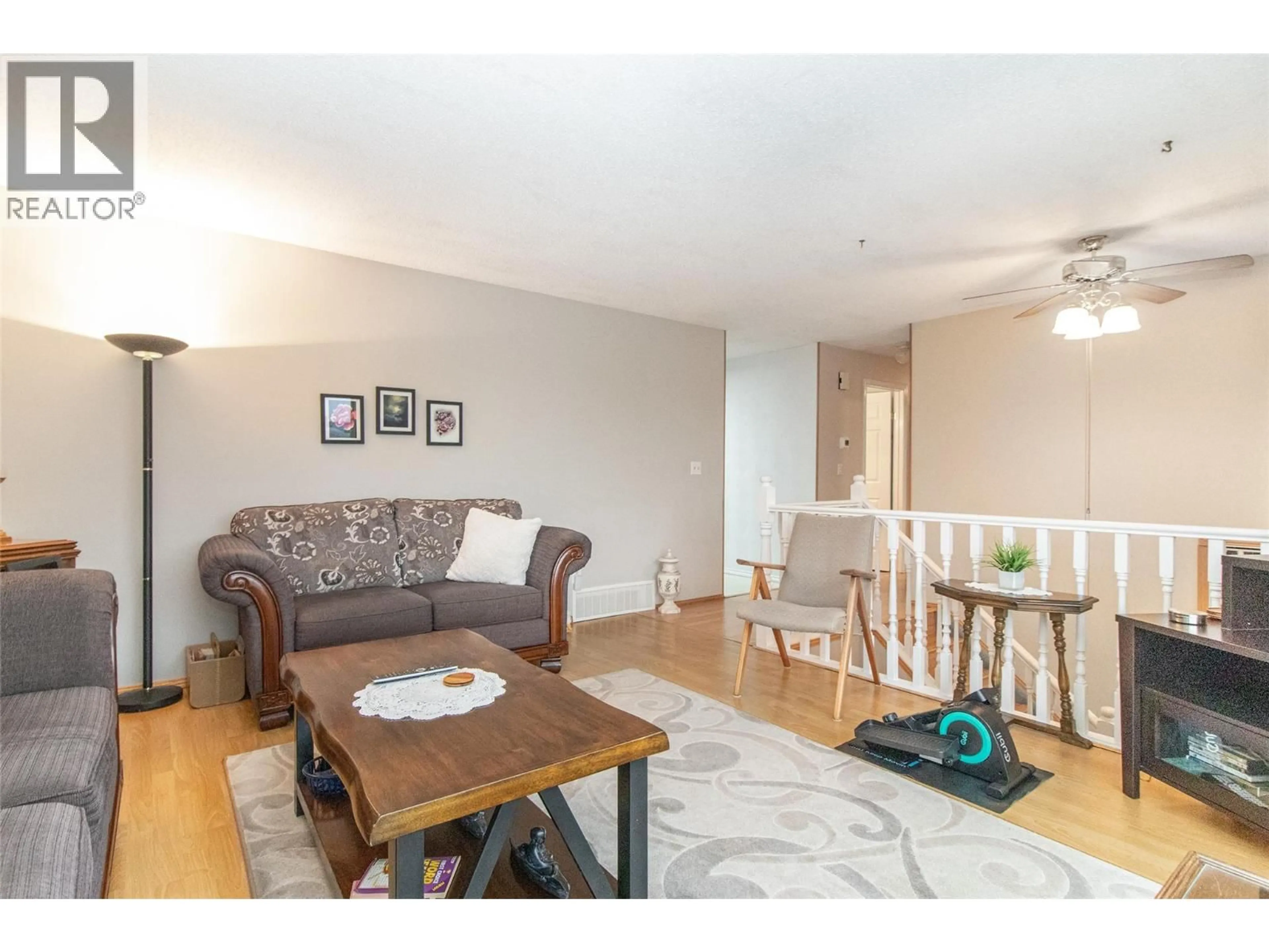 Living room with furniture, wood/laminate floor for 595 BACH ROAD, Kelowna British Columbia V1X6C9