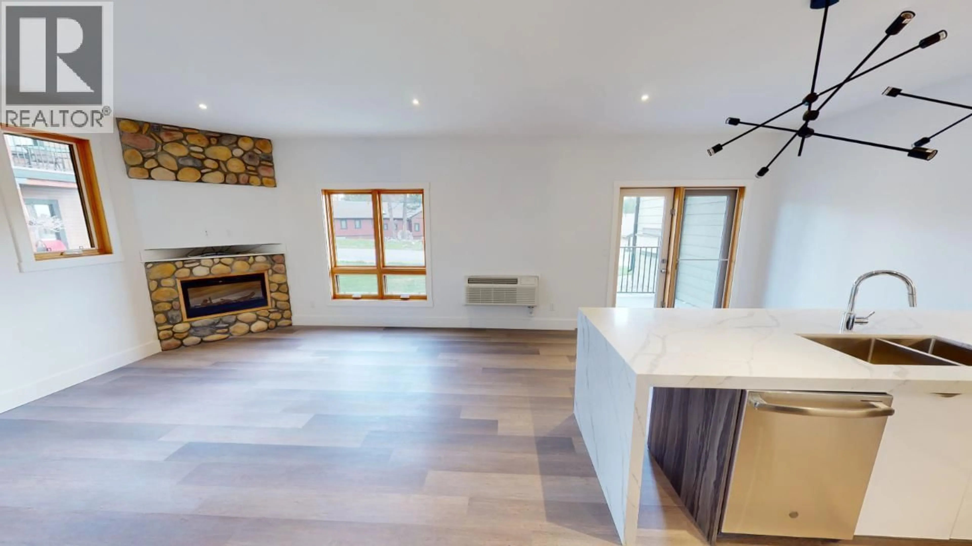 Open concept kitchen, wood/laminate floor for 401 - 7291 PROSPECTOR AVENUE, Radium Hot Springs British Columbia V0A1M0