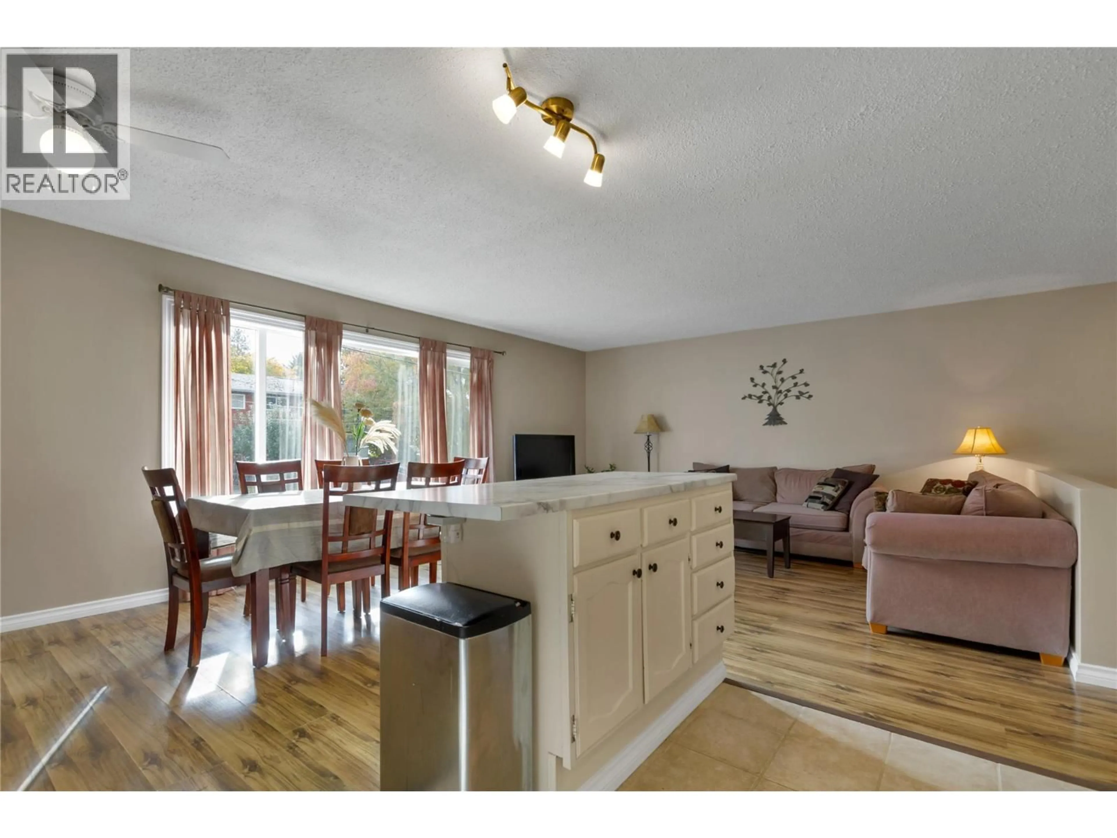 Living room with furniture, wood/laminate floor for 1711 41 AVENUE, Vernon British Columbia V1T7M8