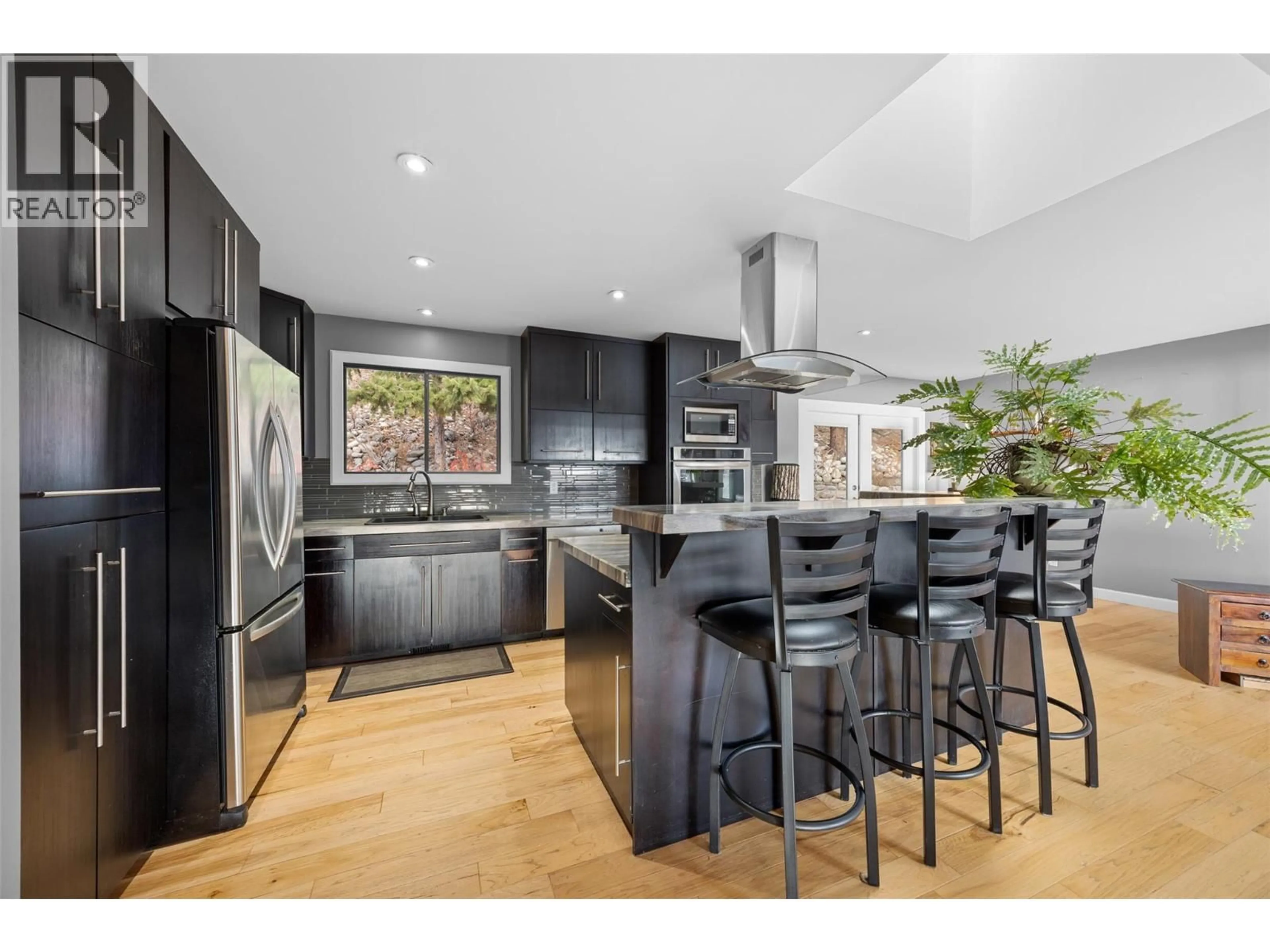 Open concept kitchen, wood/laminate floor for 4206 4TH AVENUE, Peachland British Columbia V0H1X5