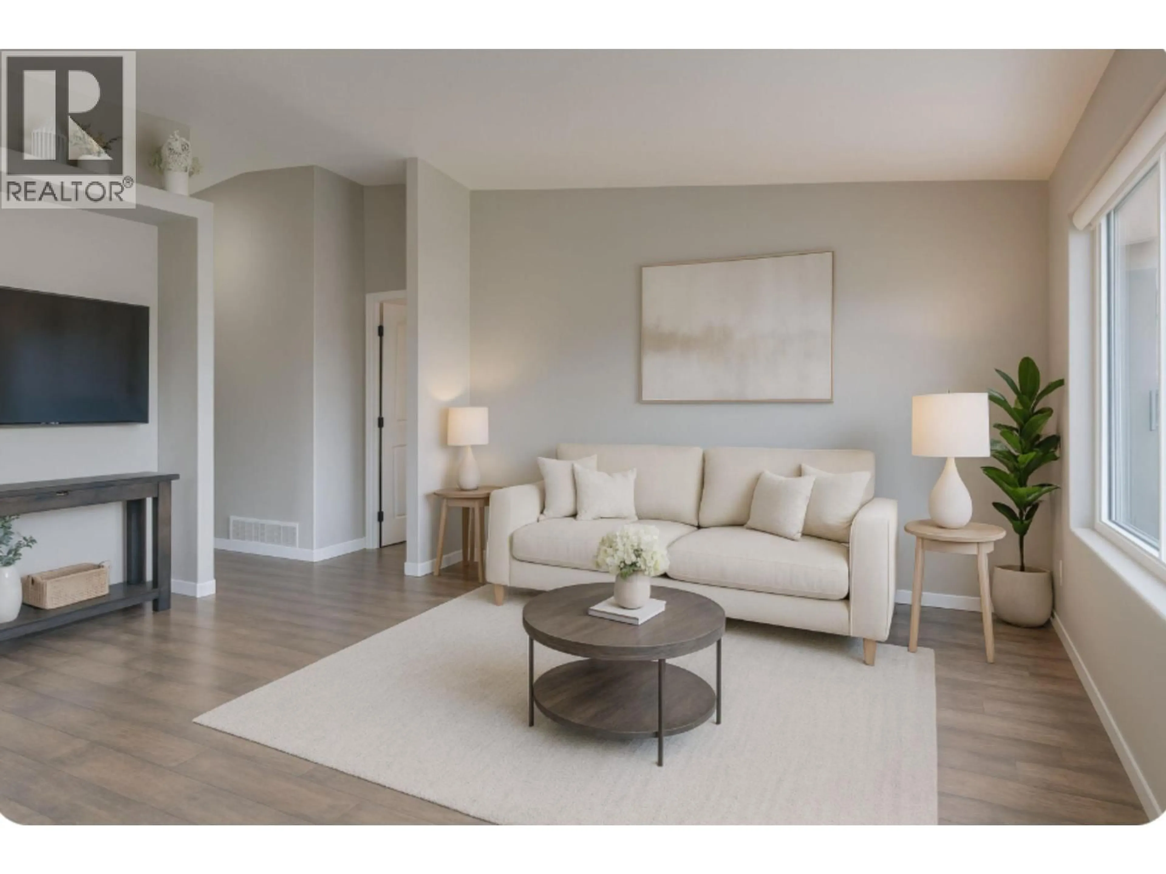 Living room with furniture, wood/laminate floor for 4 - 4700 BELLA VISTA ROAD, Vernon British Columbia V1T2N4