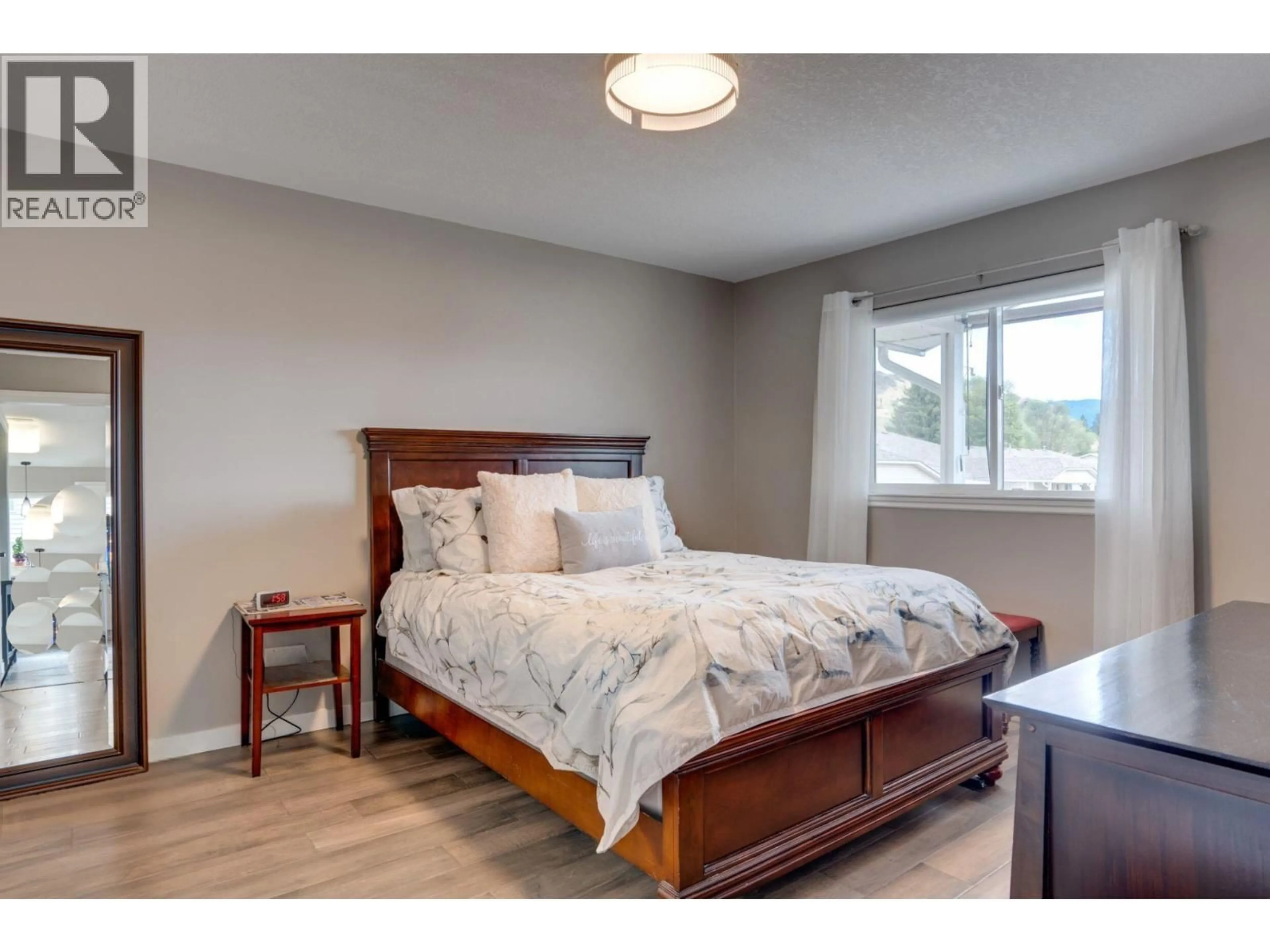 Bedroom with bed, wood/laminate floor for 4 - 4700 BELLA VISTA ROAD, Vernon British Columbia V1T2N4