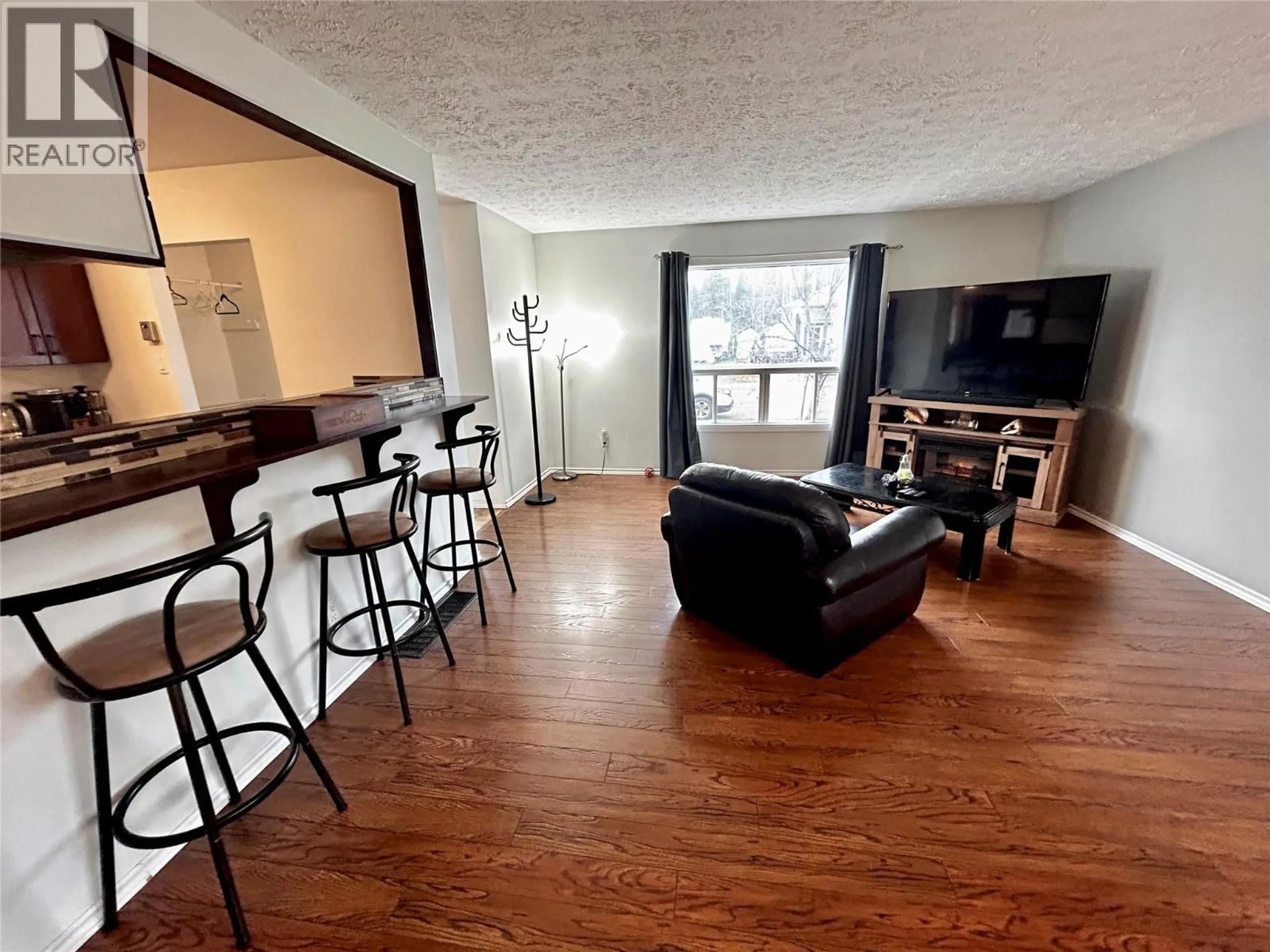 Living room with furniture, wood/laminate floor for 248 PEACE RIVER CRESCENT, Tumbler Ridge British Columbia V0C2W0
