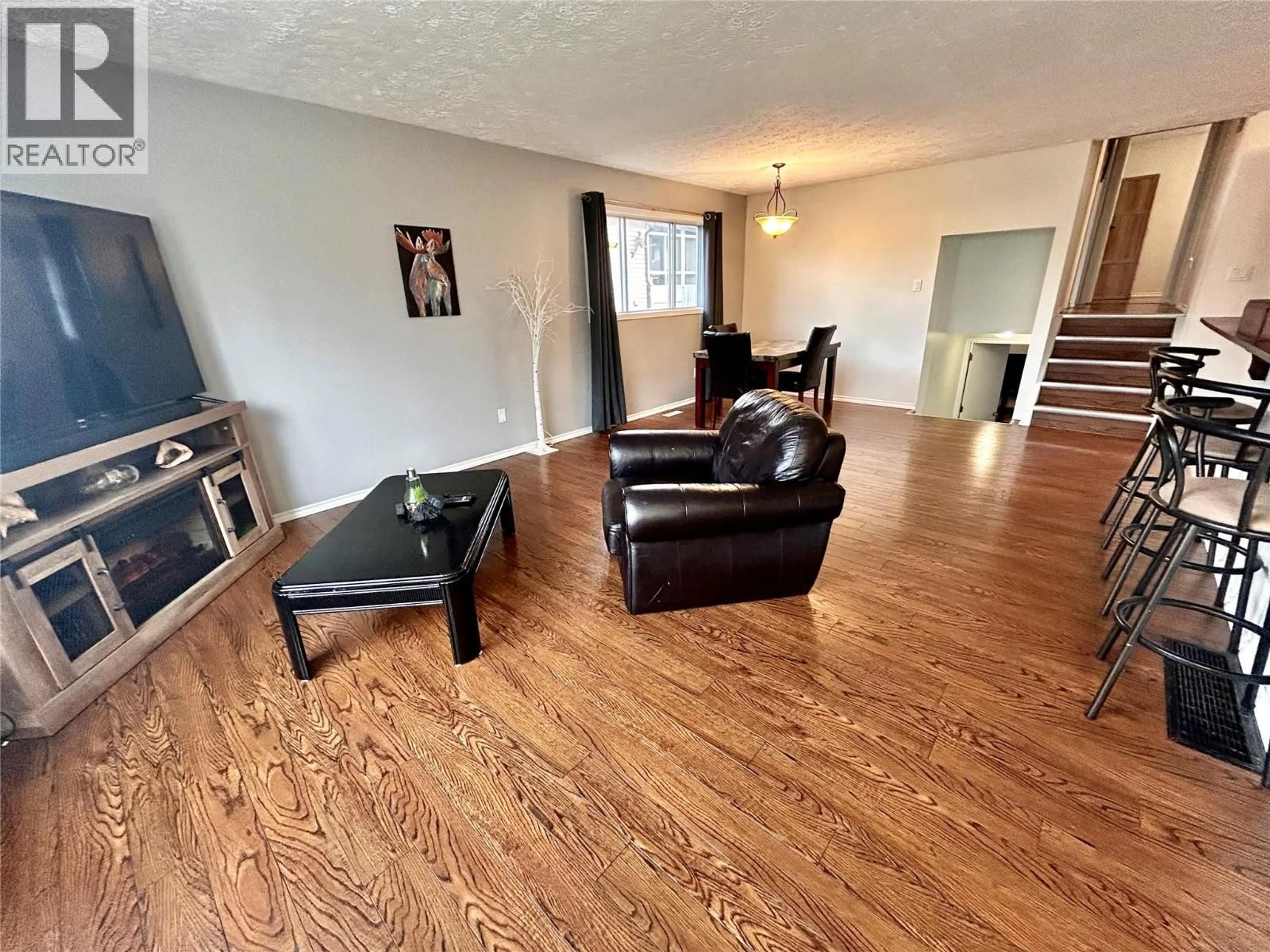 Living room with furniture, wood/laminate floor for 248 PEACE RIVER CRESCENT, Tumbler Ridge British Columbia V0C2W0