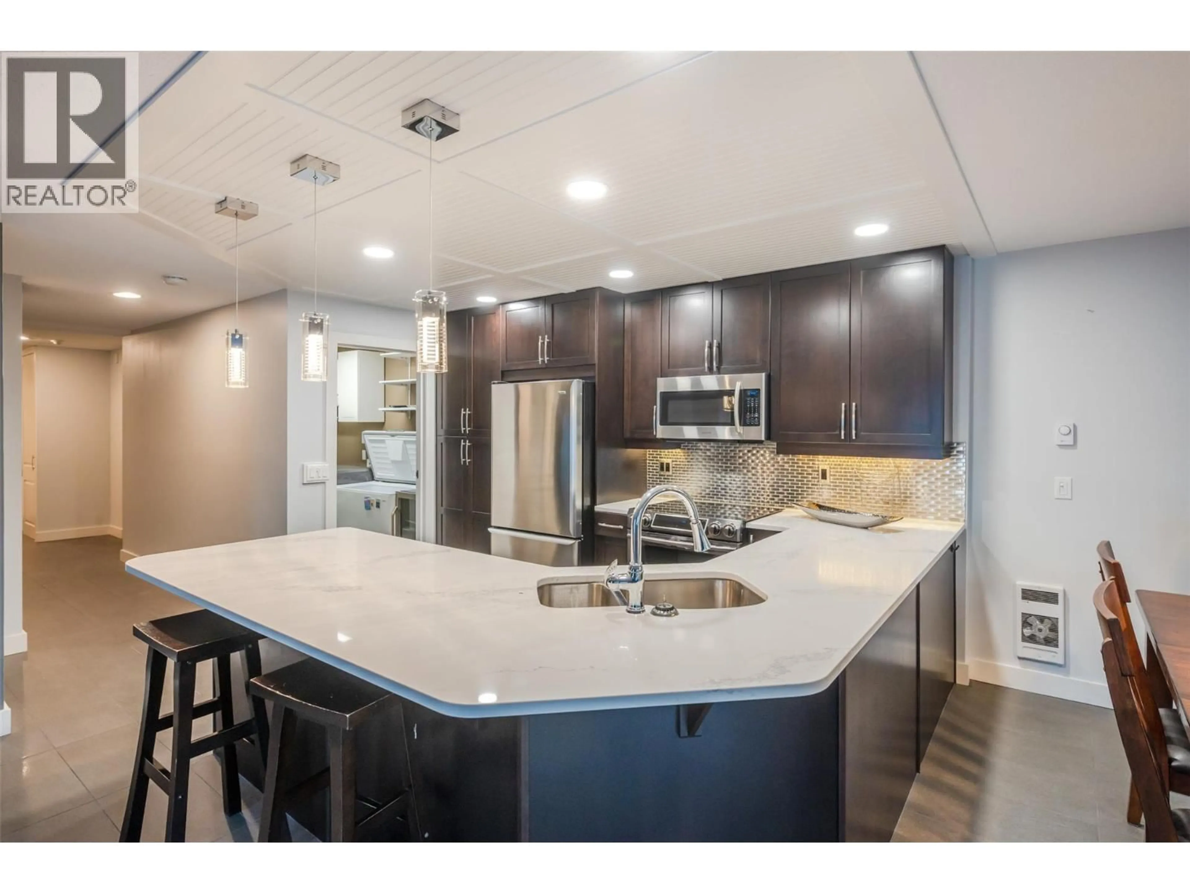 Open concept kitchen, ceramic/tile floor for 204 - 737 LEON AVENUE, Kelowna British Columbia V1V8I6